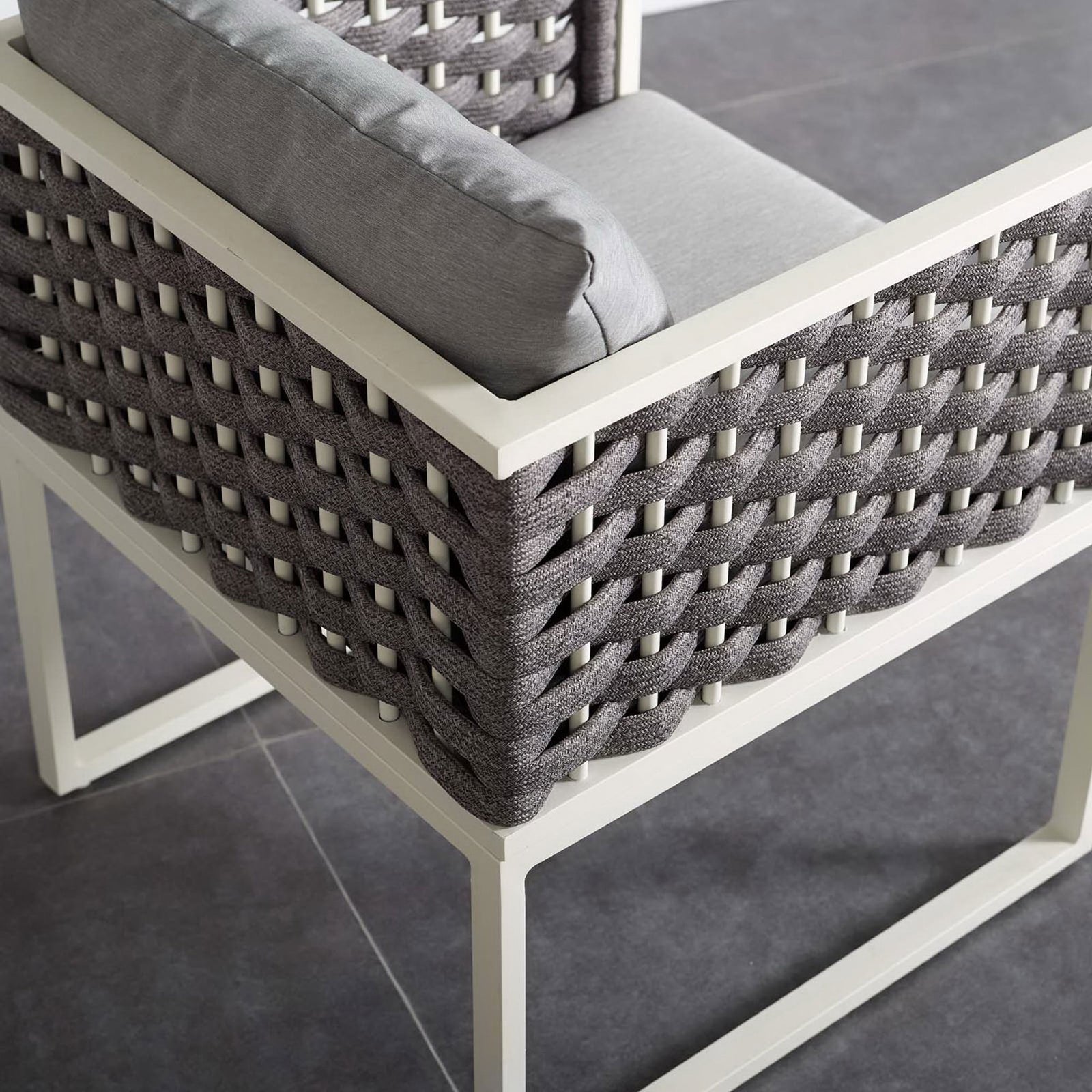 Gray cushioned patio armchair corner showing textured rope sides and open square base on tile floor || EEI-3053-WHI-GRY || detail_room