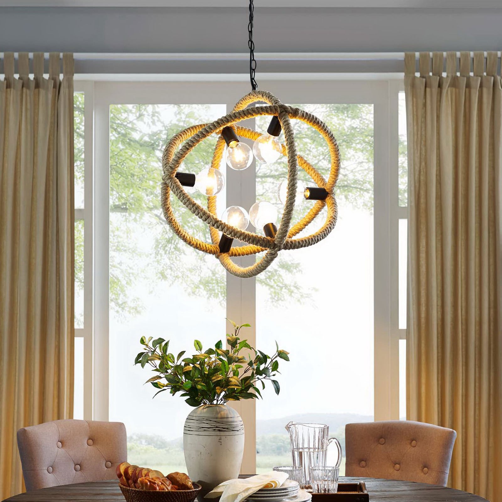 Warm glow showcases the rope orb chandelier above a dining table for cozy farmhouse ambiance || EEI-3076 || front_on_room