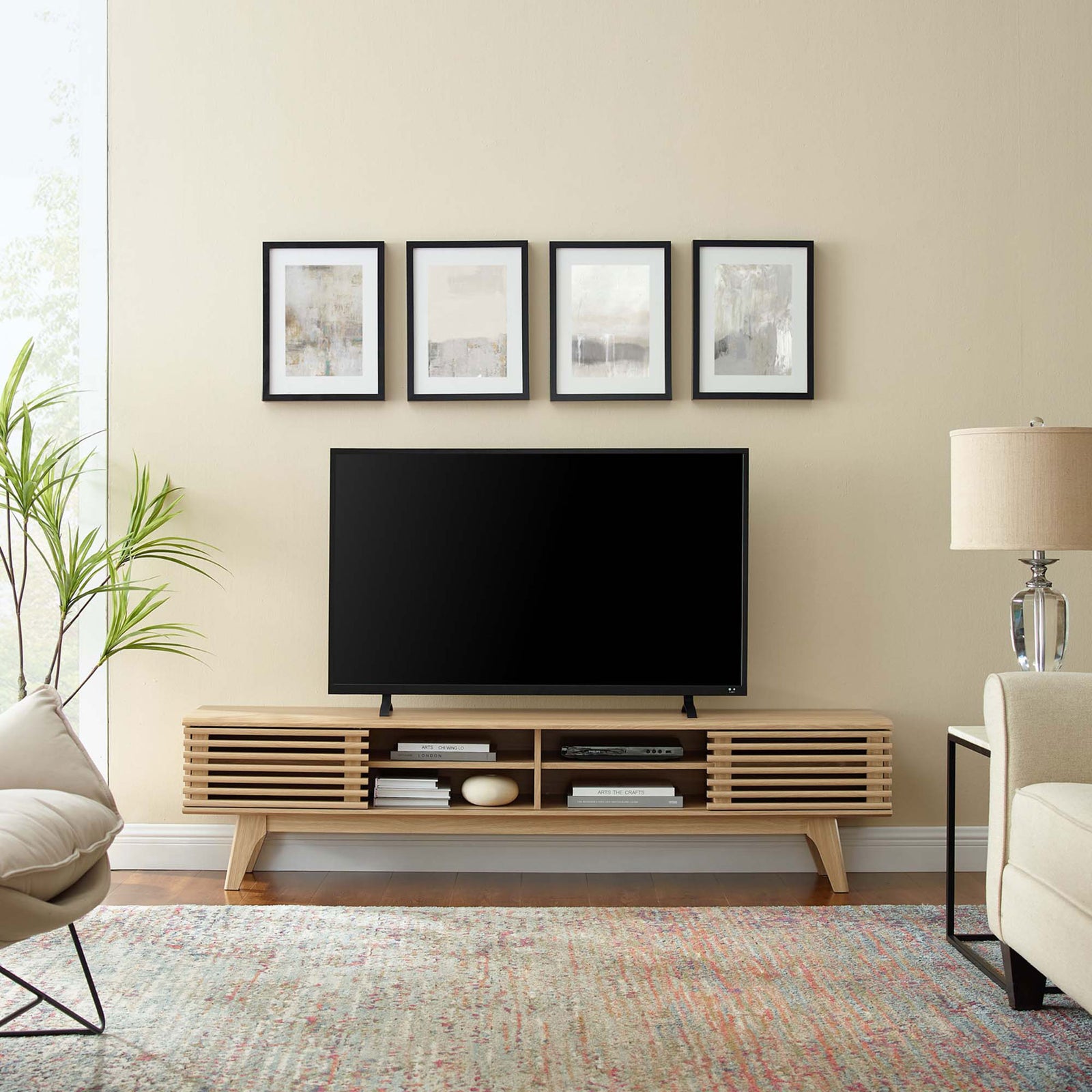 Oak Render TV stand styled in a bright living room beneath wall art with rug, accent chair, and floor lamp || EEI-3303-OAK || front_room