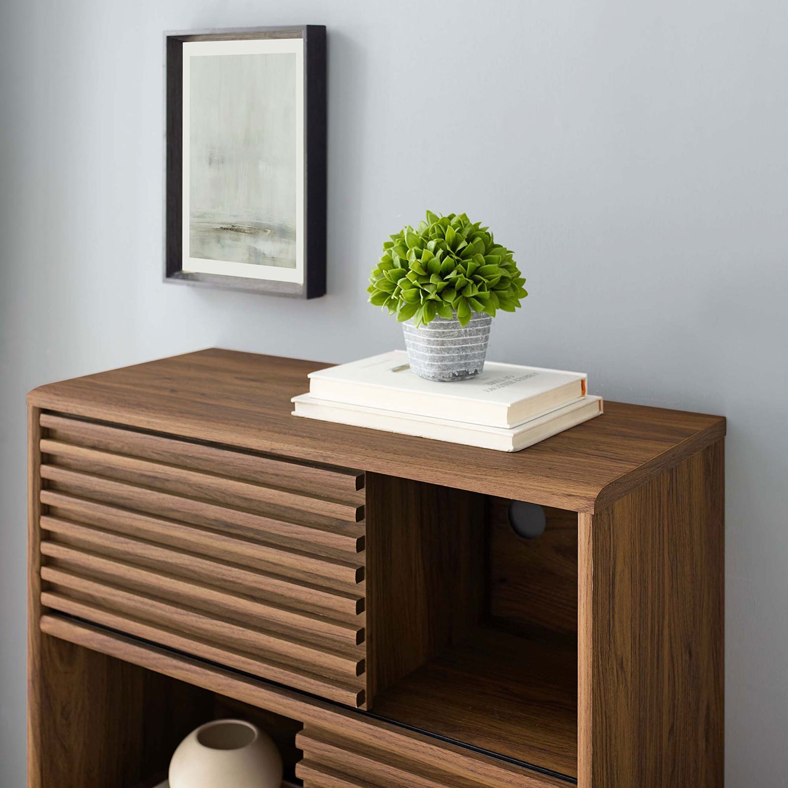 Top surface of the Render walnut cabinet styled with books and decor highlighting the wood grain finish || EEI-3343-WAL || swatch_room