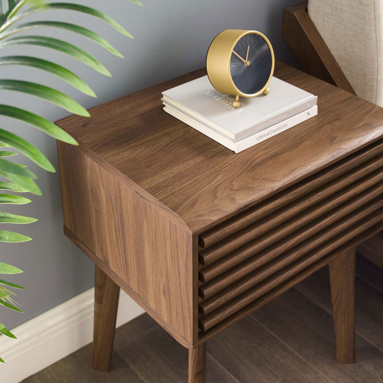 Render end table top styled with decor, showing rich walnut finish and softly rounded front corners || EEI-3345-WAL || detail_room