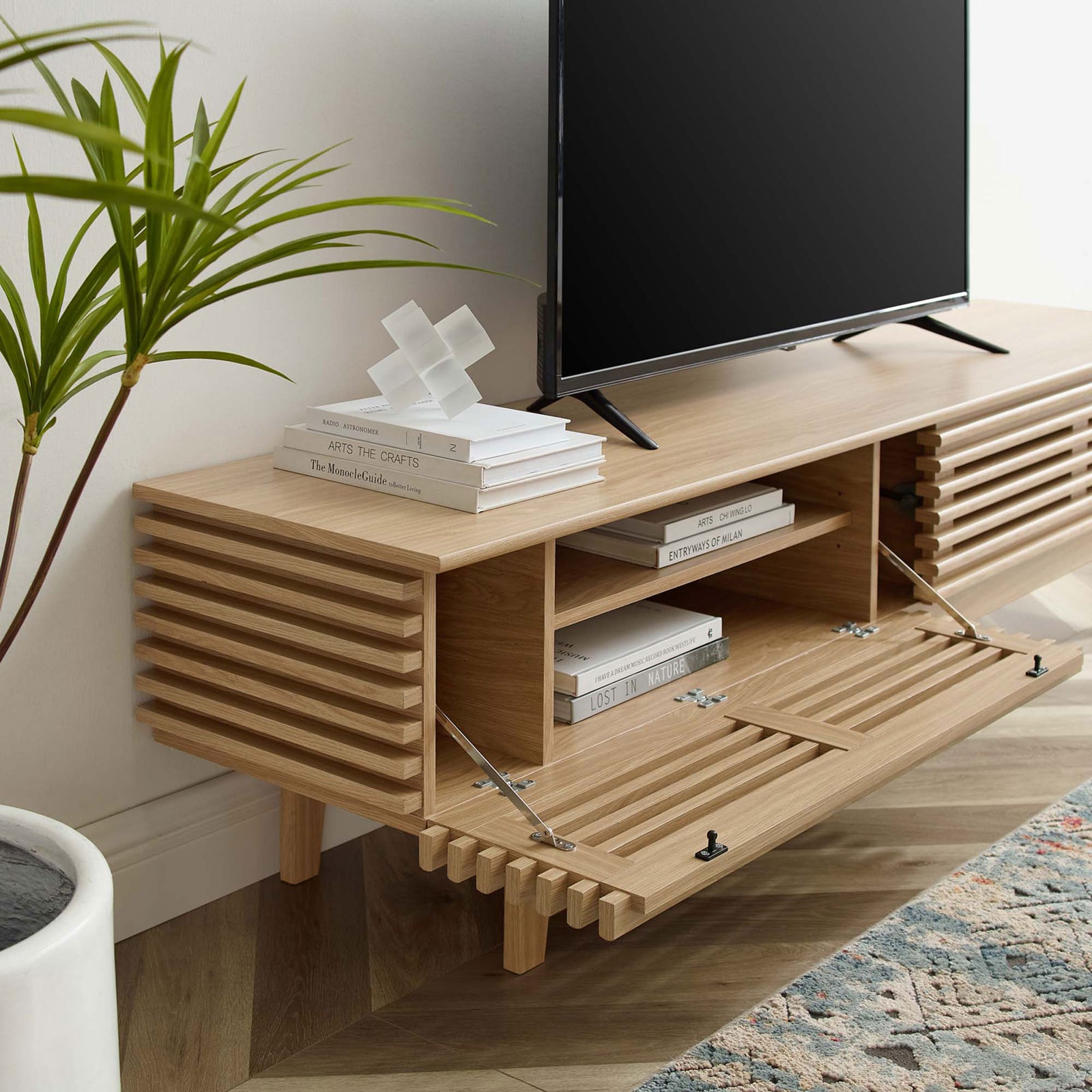 Oak TV stand in a living room with drop-down doors open to reveal media storage. || EEI-3348-OAK || front_angle_open_room