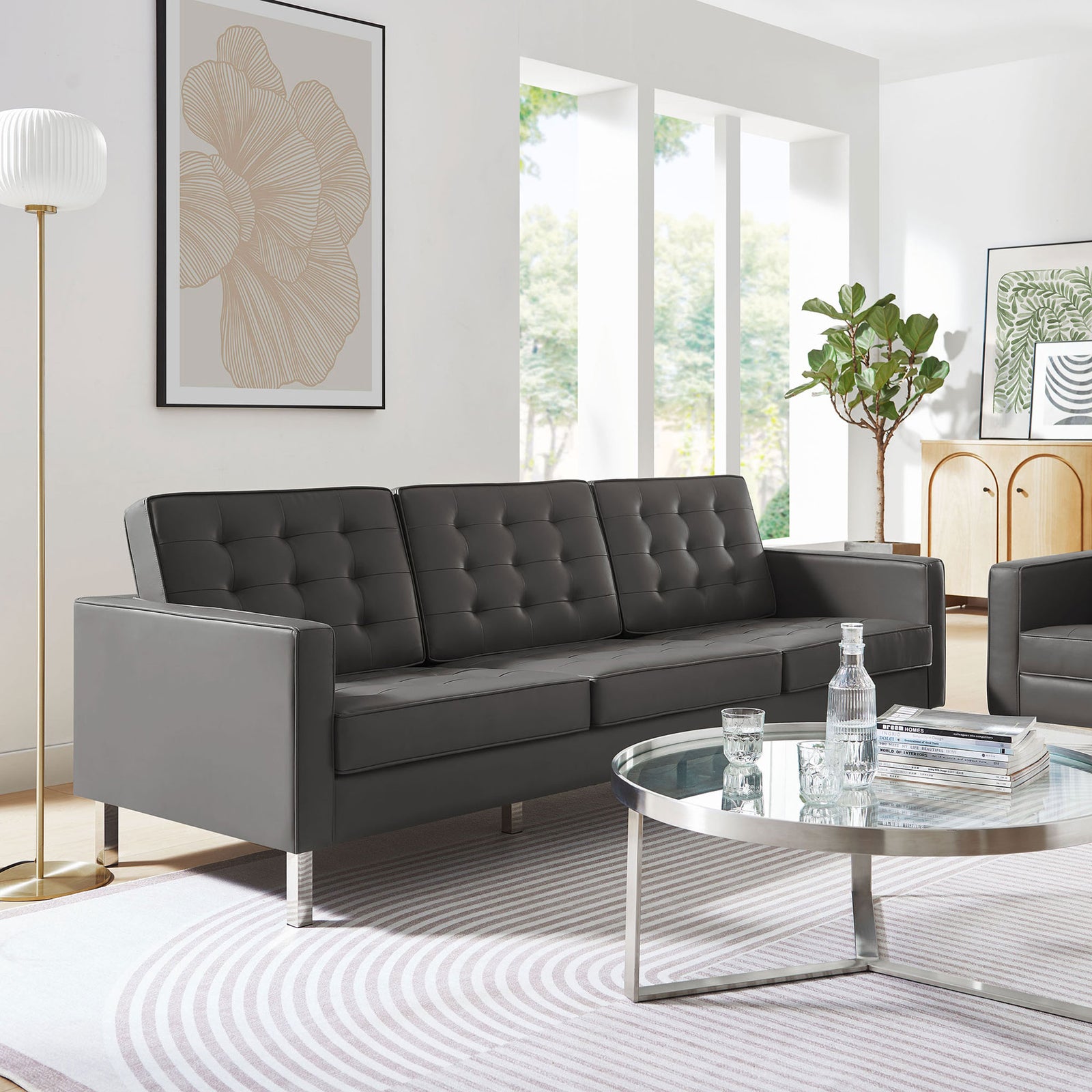 Modern gray vegan leather sofa anchoring a contemporary living room with glass coffee table and greenery || EEI-3385-SLV-GRY || front_angle_room