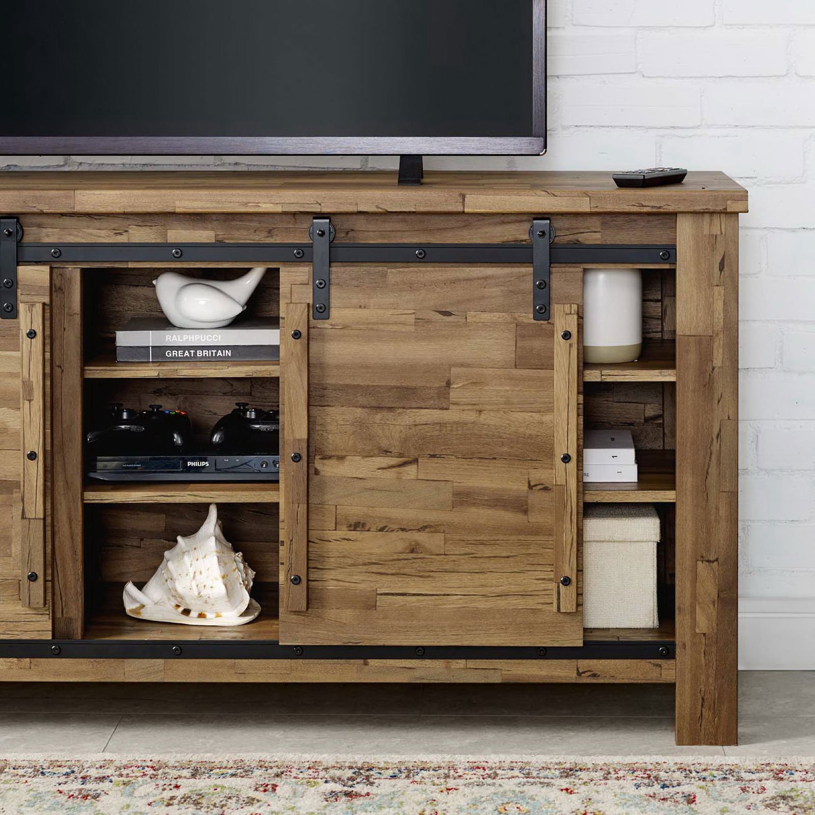 TV stand storage shelves holding books and decor with sliding barn door revealing media components || EEI-3489-WAL || storage_room