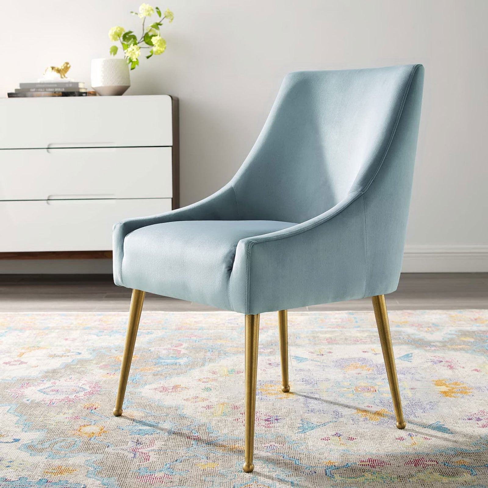 Light blue velvet dining chair with gold legs adding soft color to a bright contemporary dining space || EEI-3508-LBU || front_angle_room
