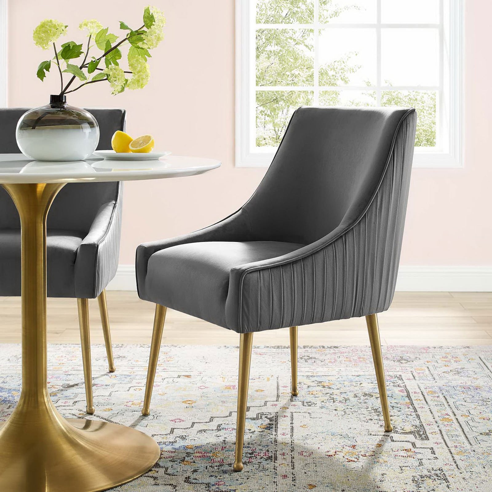 Gray velvet dining chair with gold legs styled as a pair around a round table in an airy dining room. || EEI-3509-GRY || front_angle_room