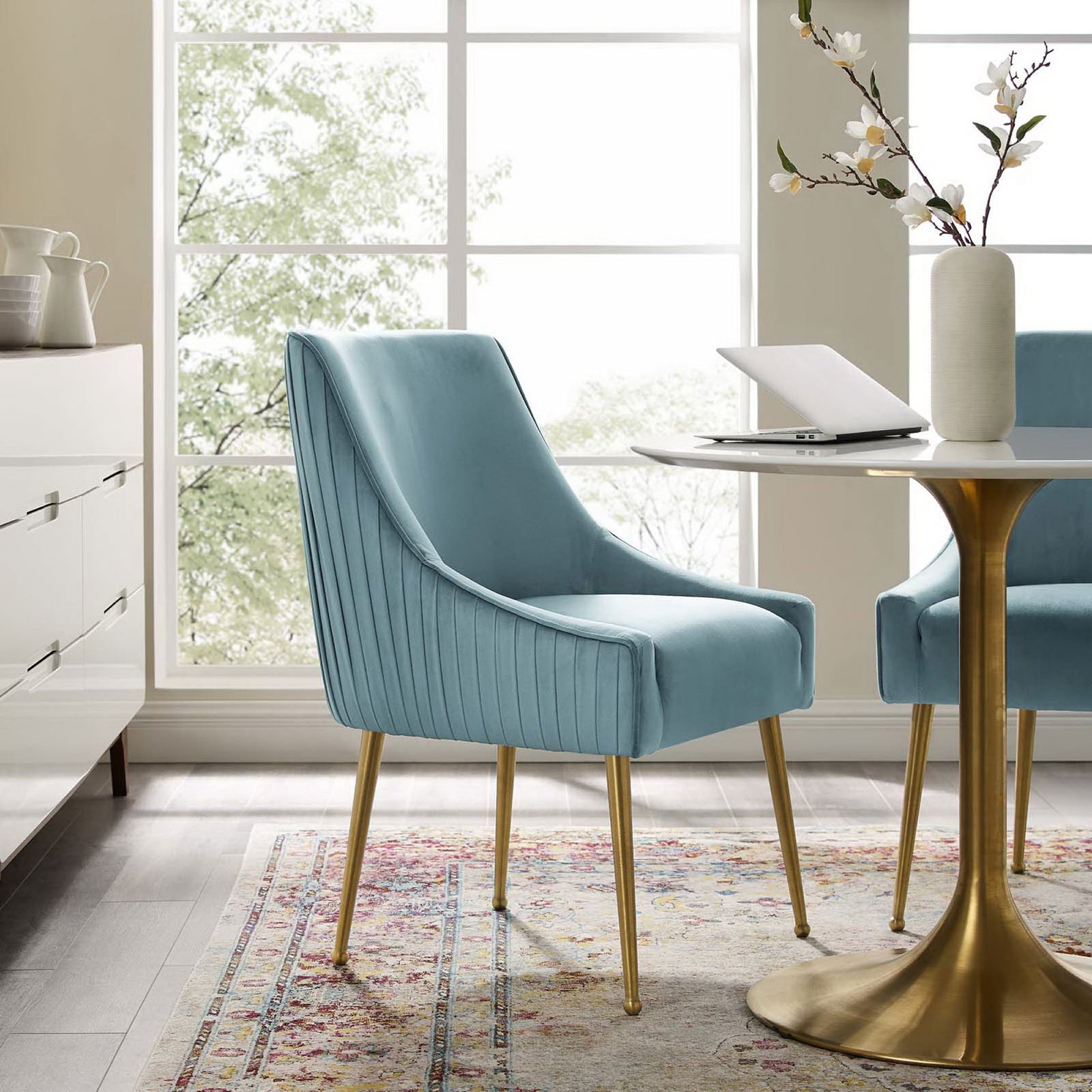 Light blue velvet accent chairs with pleated backs around a modern white and gold pedestal dining table || EEI-3509-LBU || front_angle_room