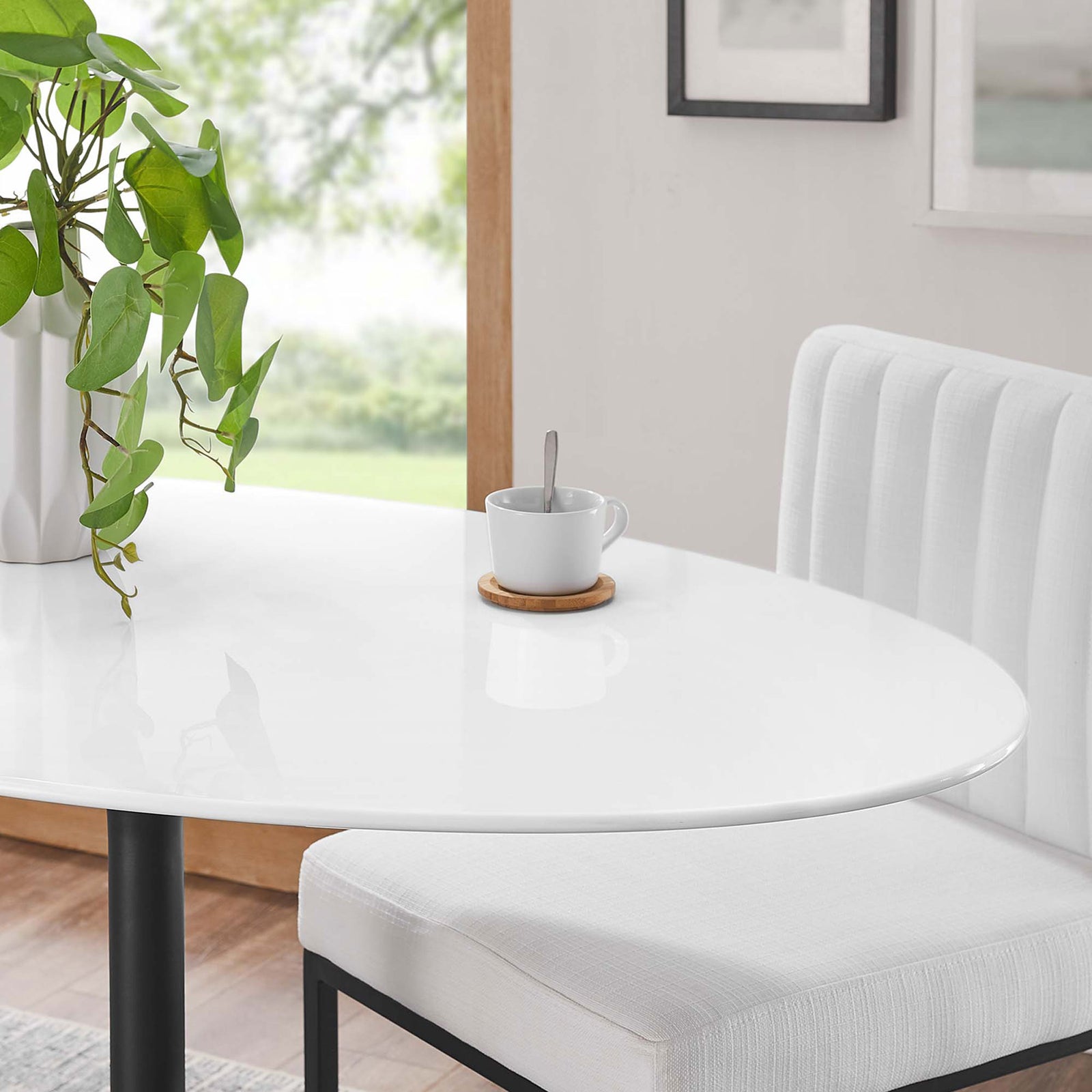 Glossy white tabletop surface shown with greenery and coffee cup for a fresh, inviting dining look || EEI-3517-BLK-WHI || detail_room