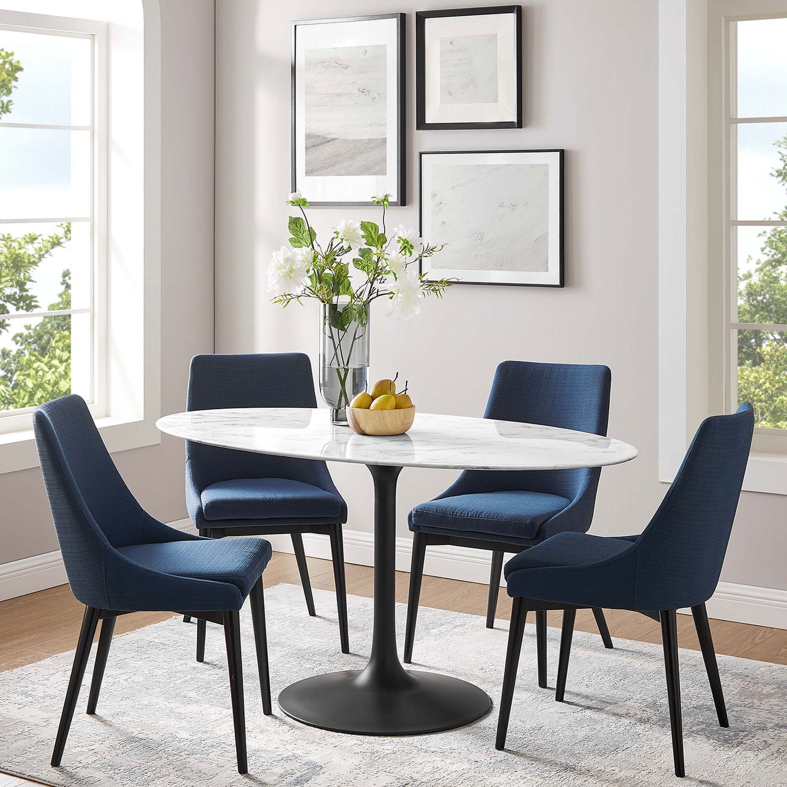 Lippa 60 inch oval faux marble dining table with black pedestal base centered in a stylish modern dining room || EEI-3531-BLK-WHI || front_angle_room