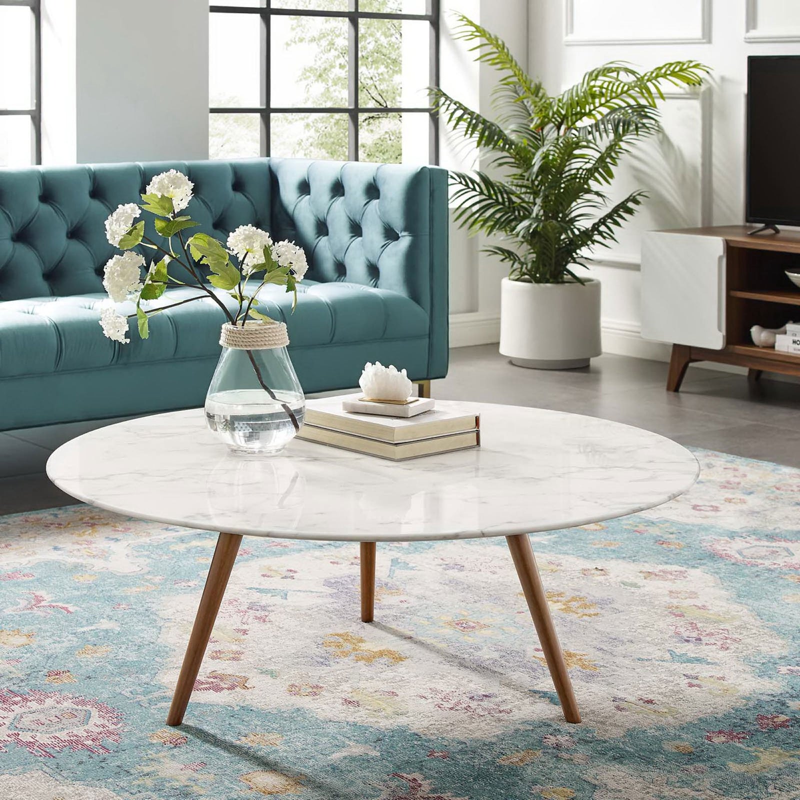 Sleek round coffee table anchors the living room with a bright faux marble top and warm wood legs || EEI-3668-WAL-WHI || front_angle_room