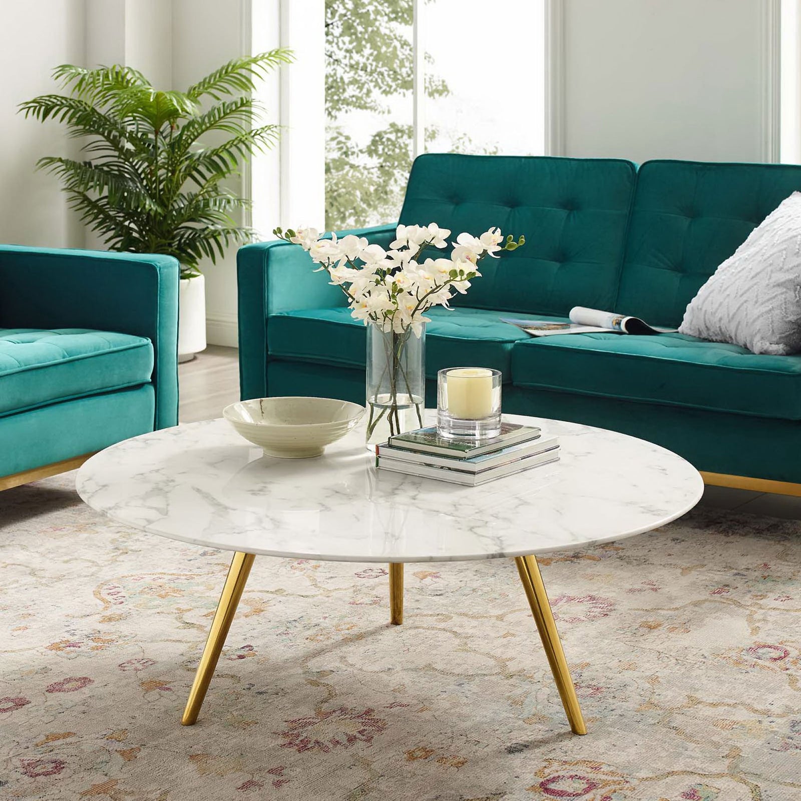 Modern faux marble coffee table anchors the room with a gold tripod base and airy profile || EEI-3672-GLD-WHI || front_angle_room