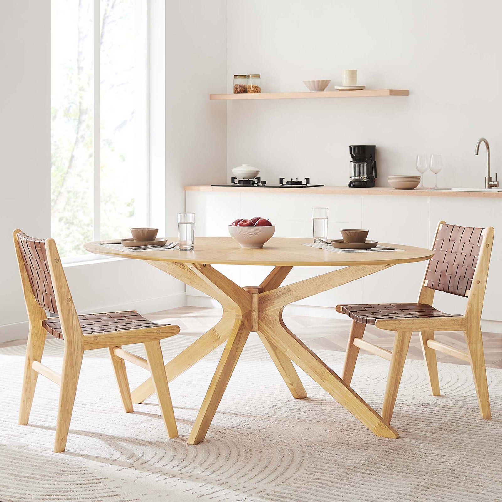 63-inch oak oval dining table styled in a bright kitchen with woven chairs and neutral dinnerware for six. || EEI-3848-OAK || front_angle_room