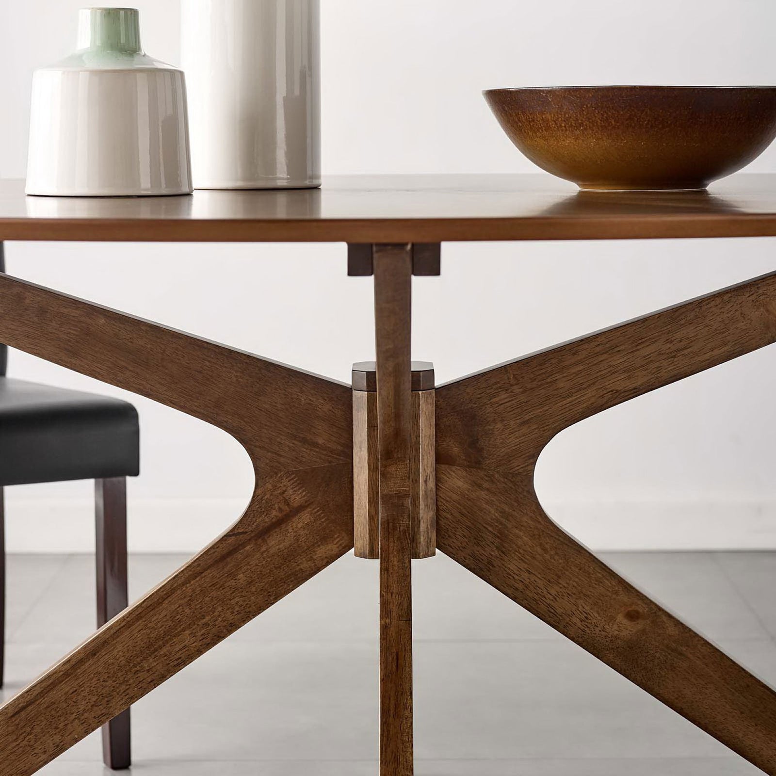 Walnut oval dining table styled with ceramic vases brings warm mid century character to the dining room || EEI-3848-WAL || front_room