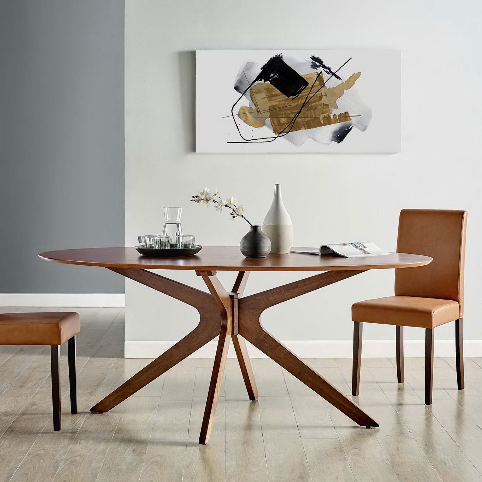 Oval walnut dining table centers a modern dining room with artwork, side chairs, and neutral flooring || EEI-3849-WAL || front_room