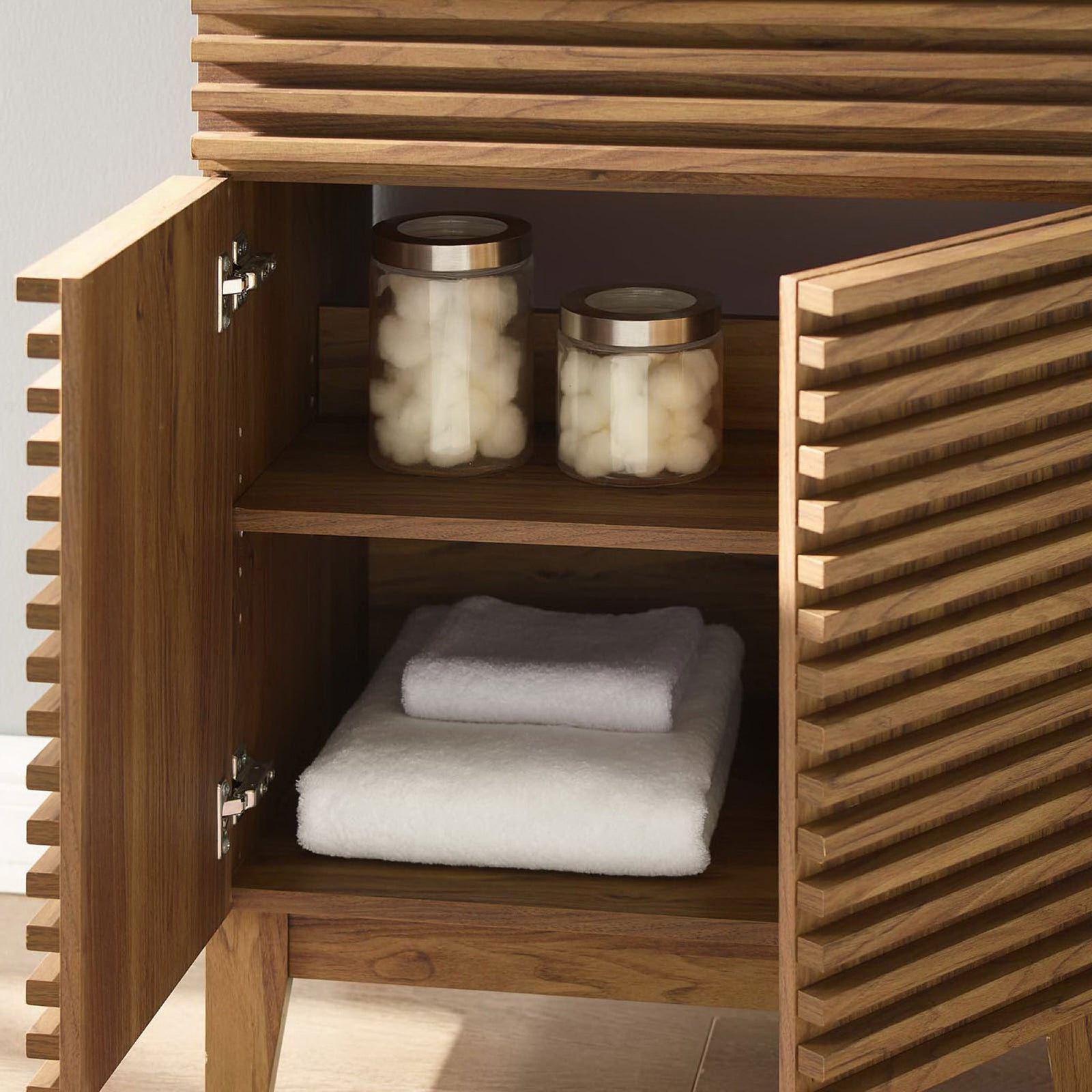 Interior shelving keeps towels and jars within reach inside the soft-close cabinet. || EEI-3860-WAL-WHI || storage_open_room