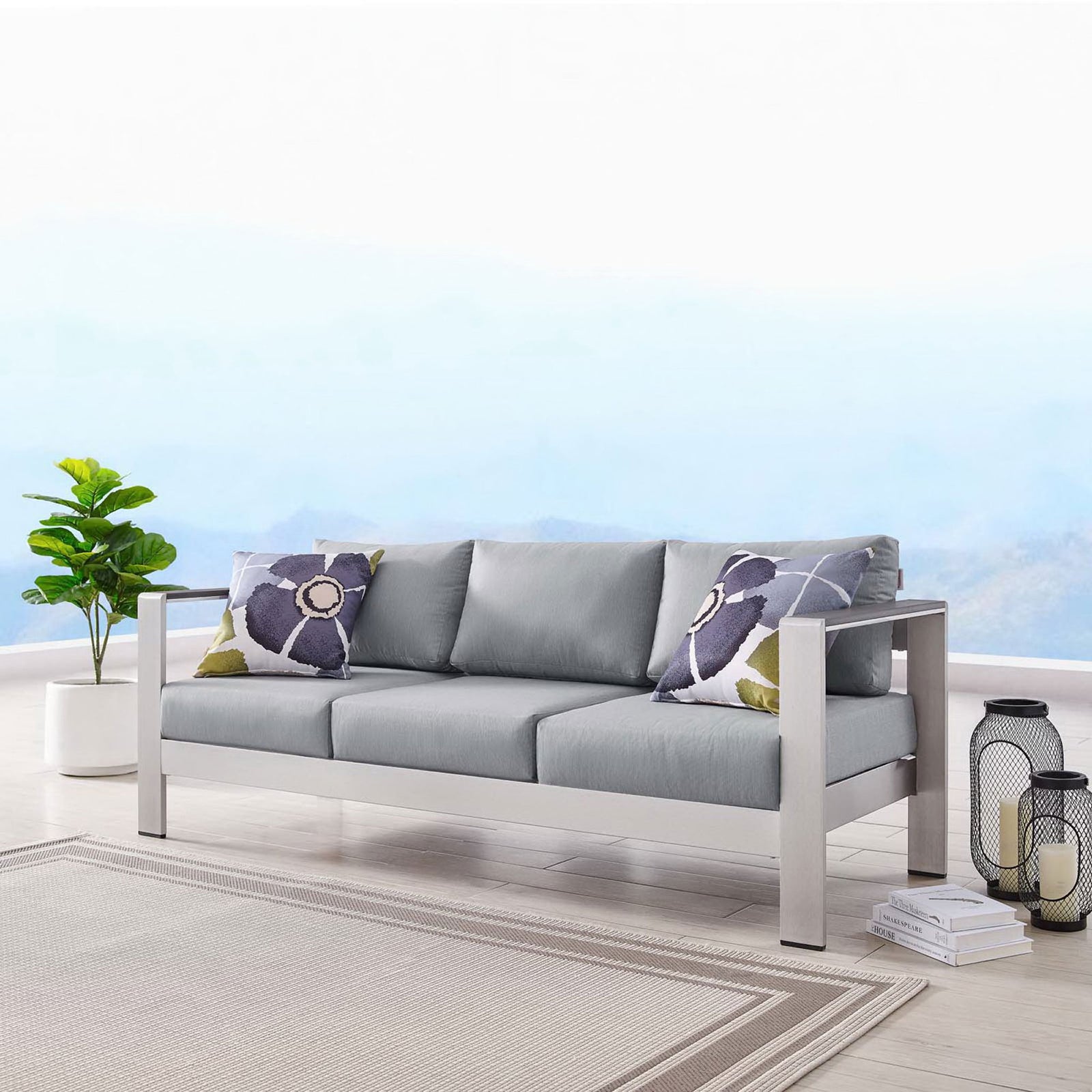 Shore sofa anchors an airy patio setting with soft gray cushions and a sleek silver frame || EEI-3917-SLV-GRY || front_angle_room