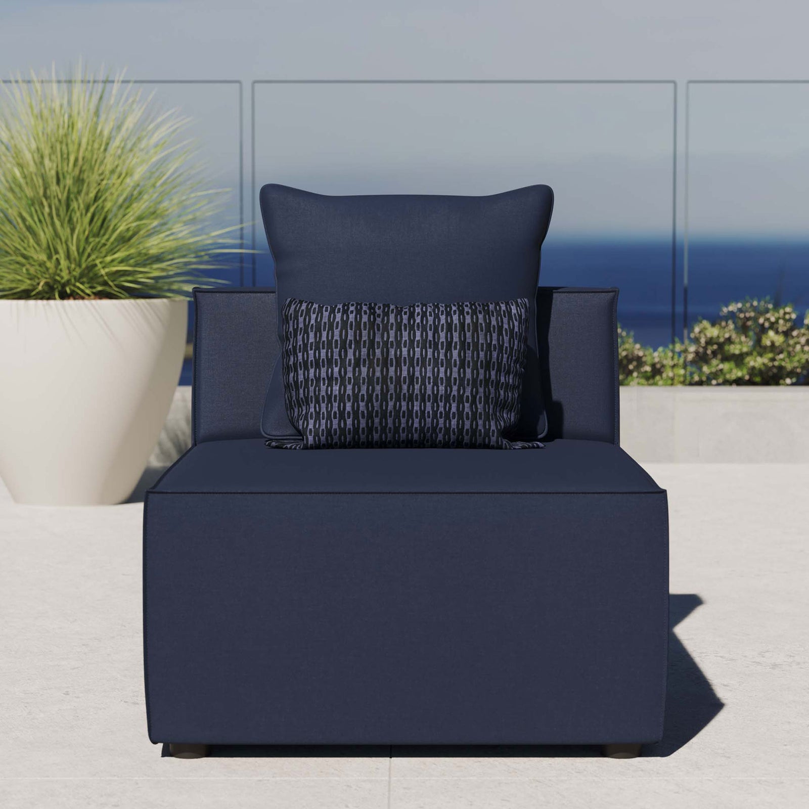 Navy blue outdoor armless sectional chair styled on a bright patio with ocean view and plush cushion comfort || EEI-4209-NAV || front_room