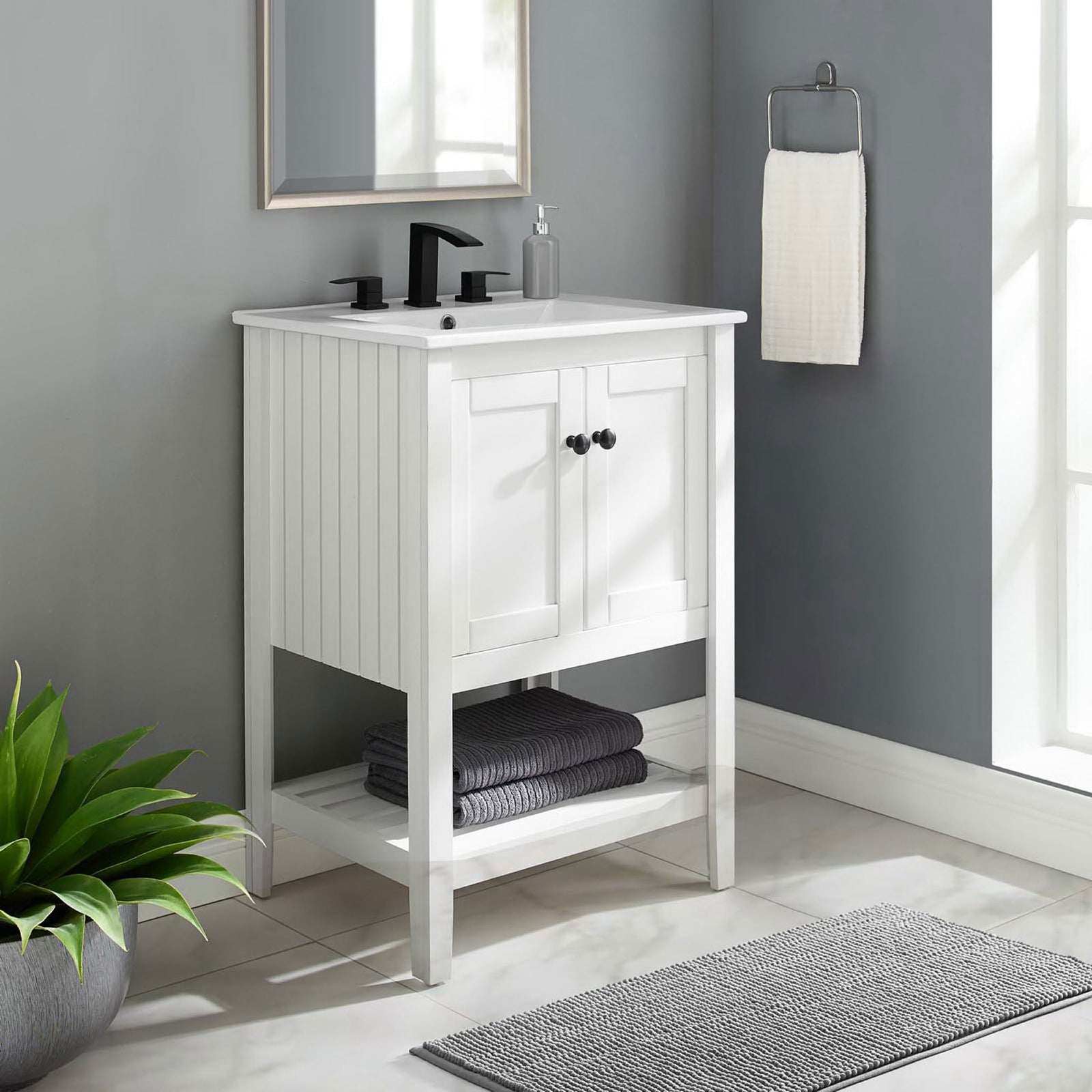 Refined vanity anchors the bath with clean lines and handy lower shelf storage || EEI-4246-WHI-WHI || front_room