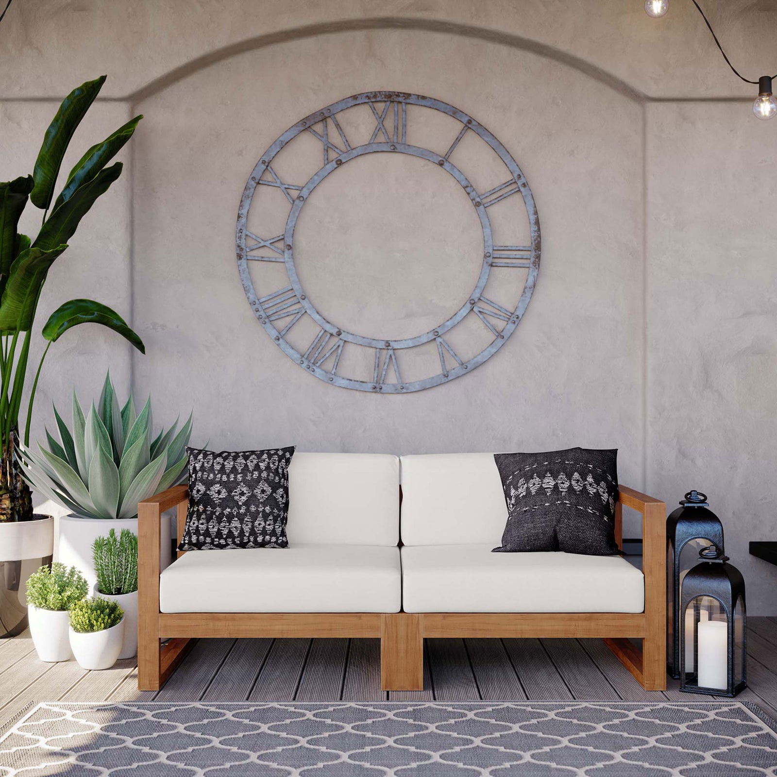 Teak outdoor loveseat with white cushions styled with patterned pillows on a covered patio || EEI-4256-NAT-WHI-SET || front_room