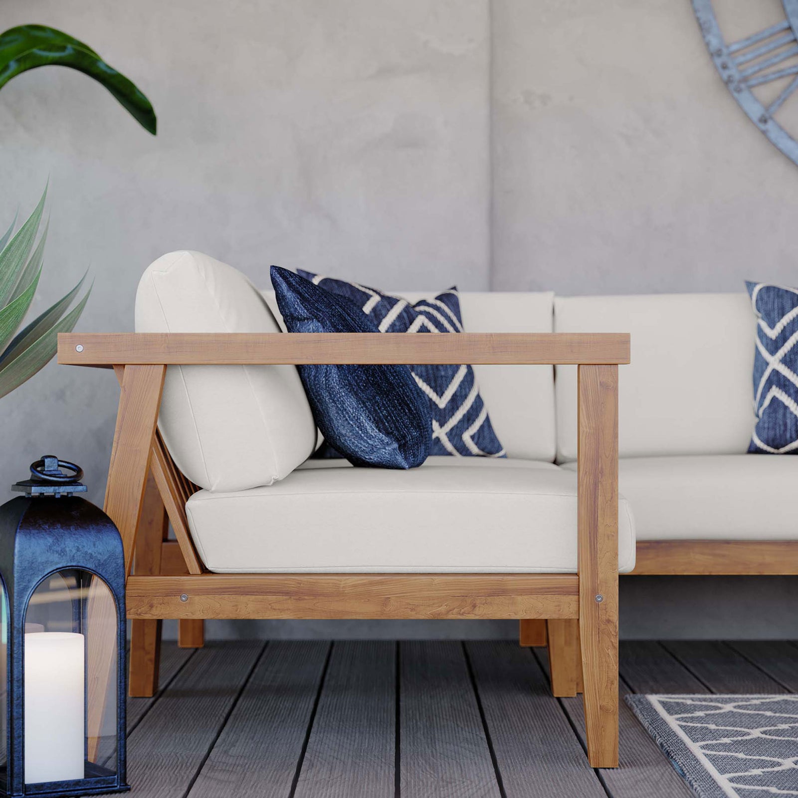 Outdoor teak sofa corner styled with white cushions, navy pillows, and lantern on a deck || EEI-4258-NAT-WHI-SET || detail_room