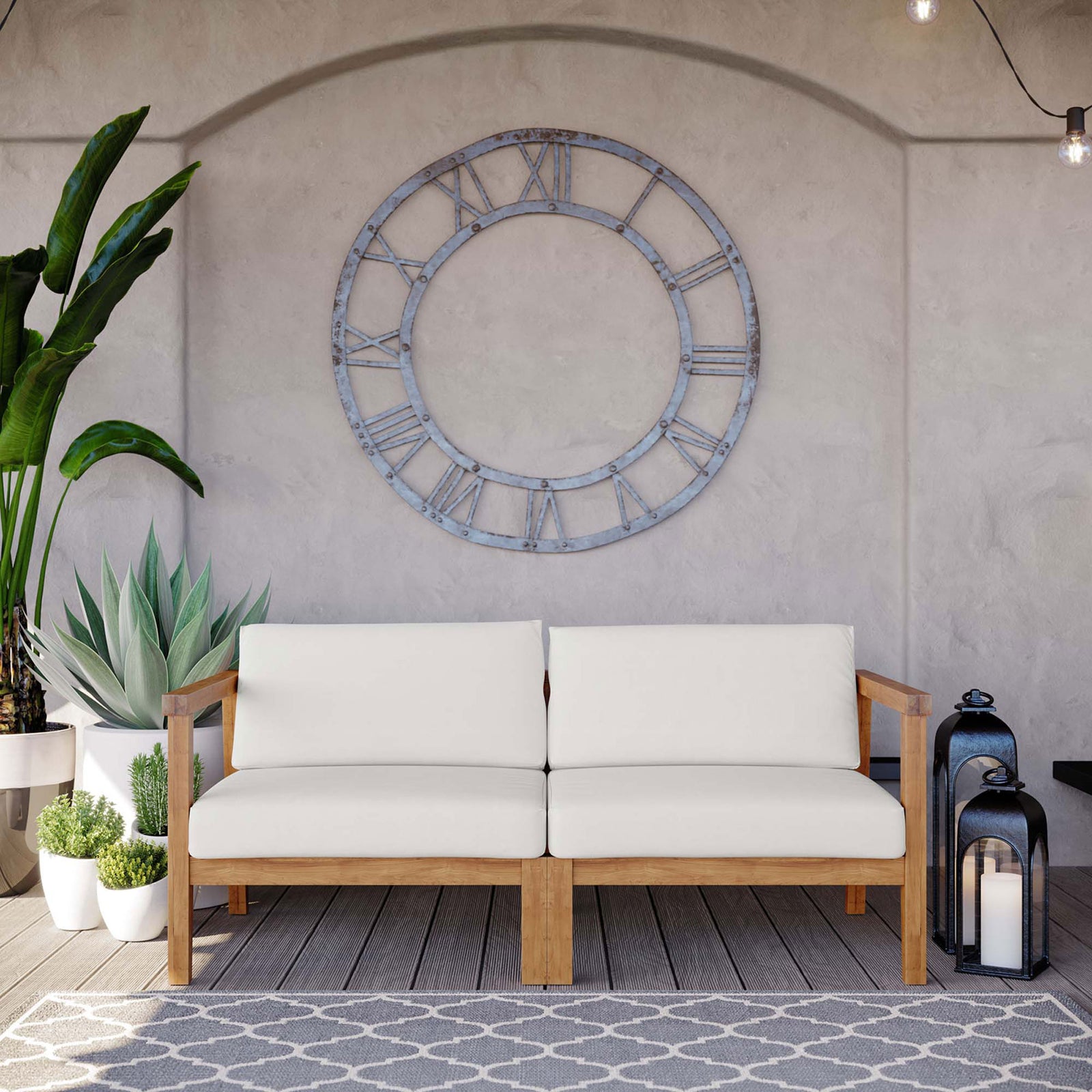 Bayport outdoor teak loveseat with white cushions styled on a covered patio with plants and lanterns || EEI-4259-NAT-WHI-SET || front_room