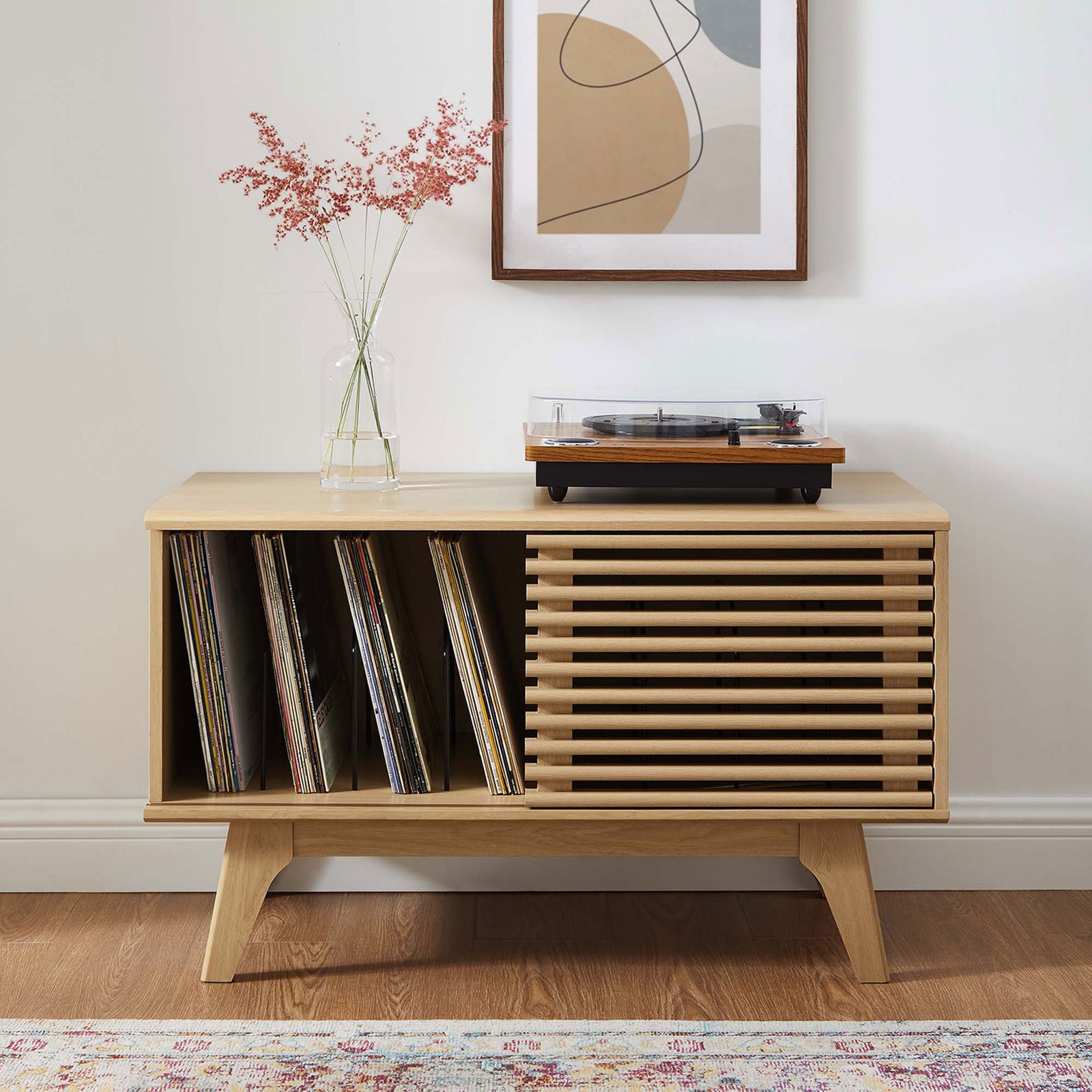 Oak record stand styled in a bright living room with albums displayed and turntable resting on top. || EEI-4263-OAK || front_open_room