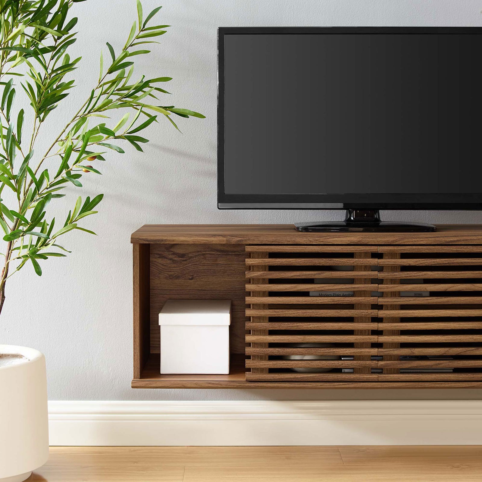 Open end cubby of the walnut TV console used for decor storage beside the slatted door. || EEI-4266-WAL || storage_room