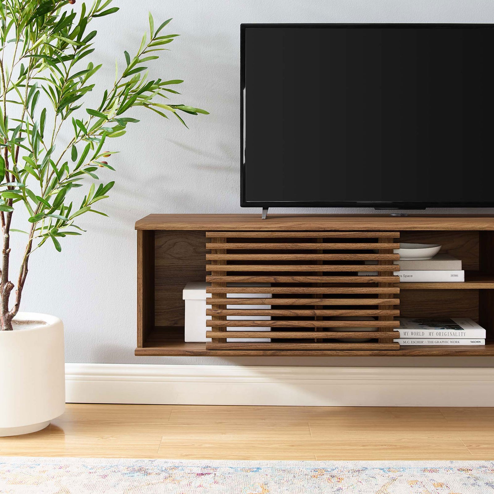 Close-up of the open storage bay of the 60 inch console with stacked books and decorative bowls. || EEI-4267-WAL || storage_room