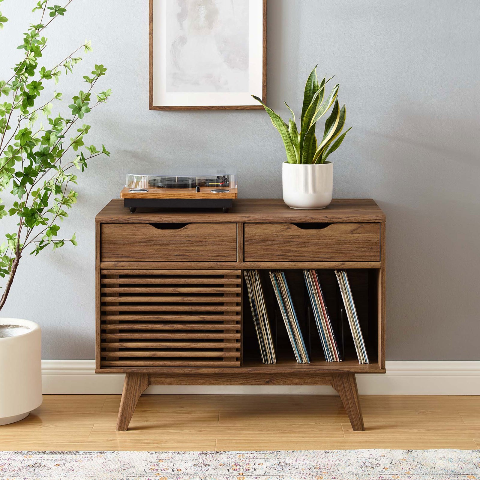 Walnut vinyl record stand centered in a stylish living room with art, plants, and storage for albums and media || EEI-4323-WAL || front_room