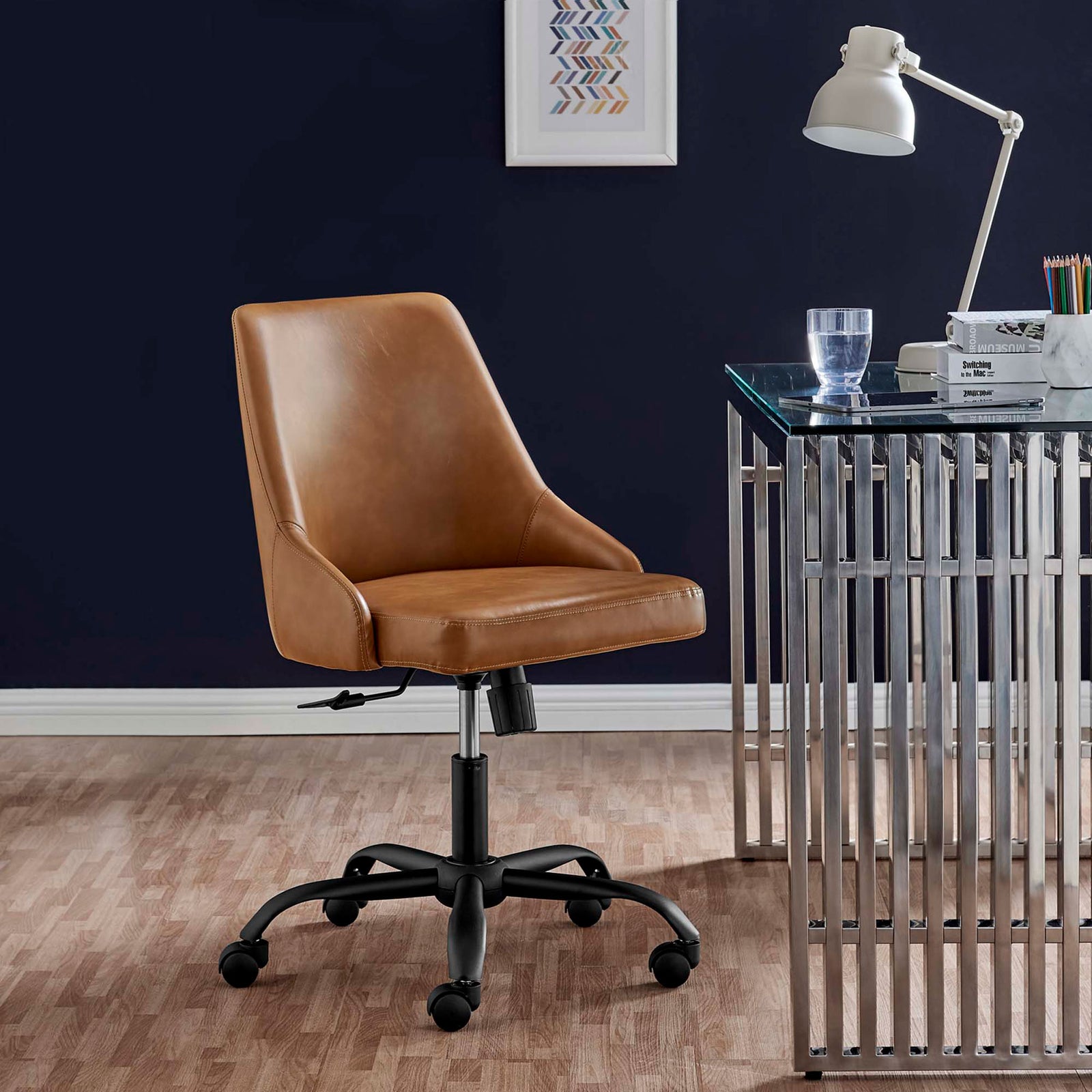 Designate tan vegan leather office chair styled with a modern glass desk and navy accent wall in a home office || EEI-4372-BLK-TAN || front_angle_room