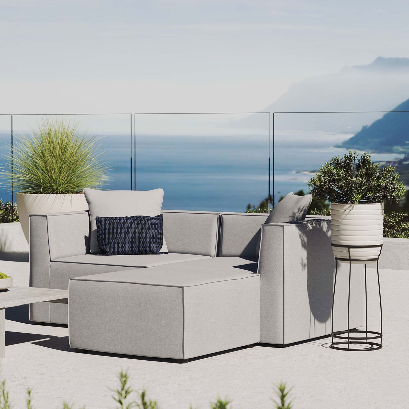 Gray outdoor loveseat and ottoman styled on a terrace for relaxed coastal-inspired entertaining || EEI-4378-GRY || front_angle_room