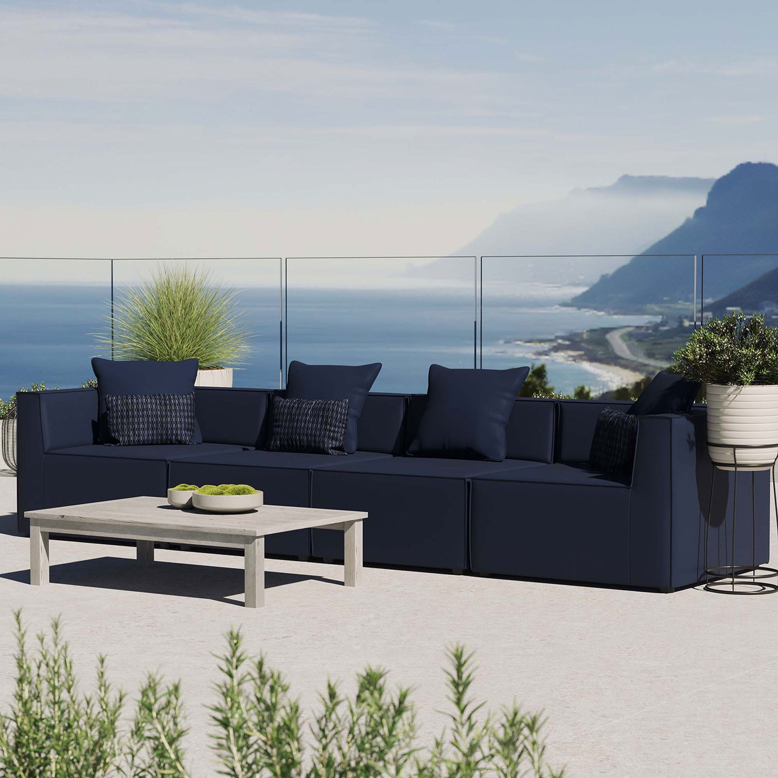 Navy 4-piece outdoor sectional sofa arranged on a coastal terrace with patterned accent pillows || EEI-4381-NAV || front_angle_room