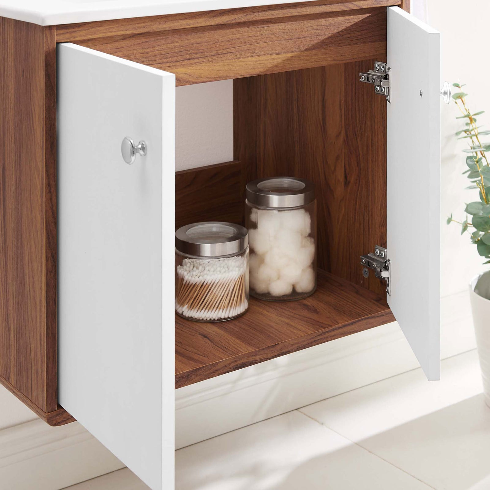 Deep shelving behind dual doors offers ample space for towels and toiletries. || EEI-4431-WAL-WHI || storage_open_room