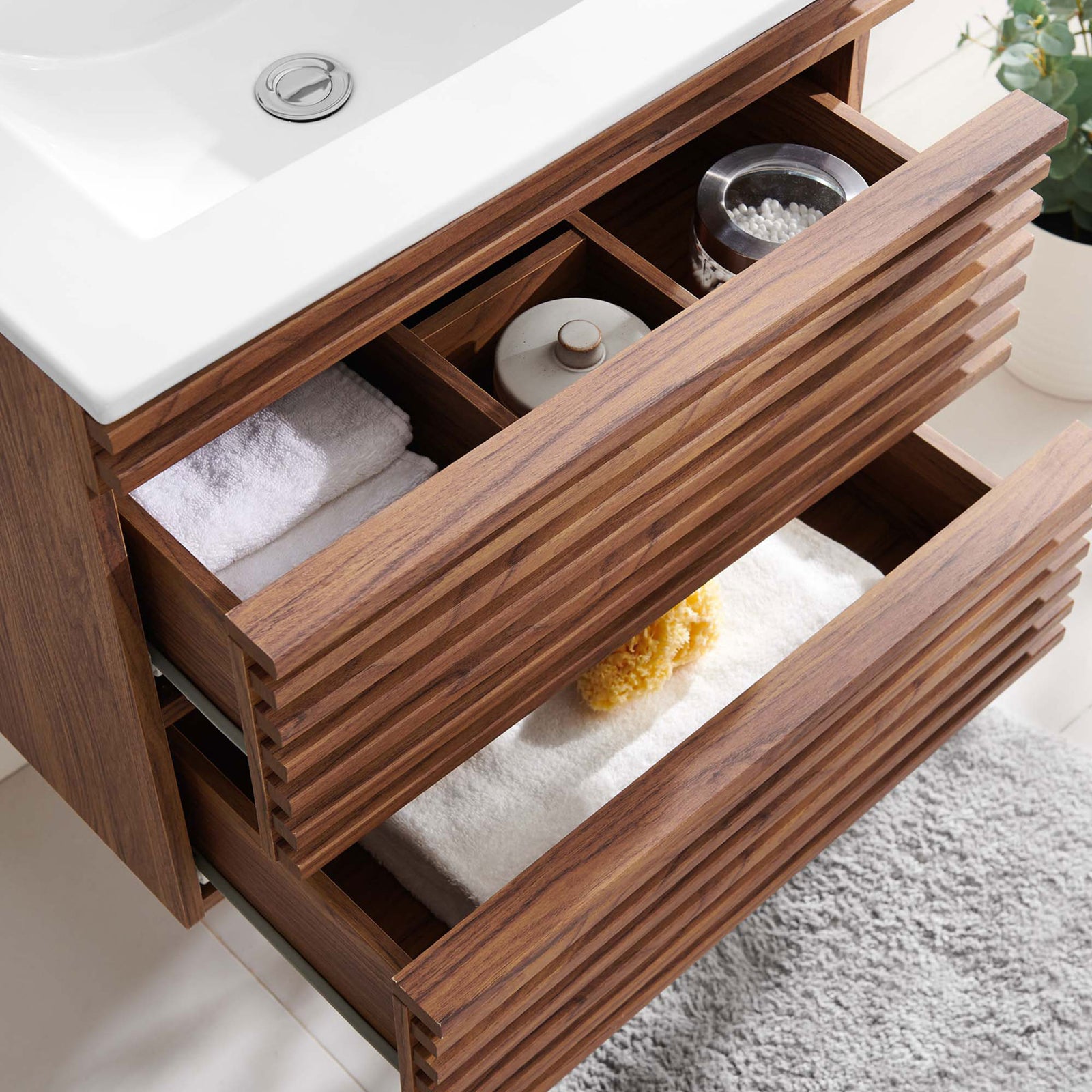 Spacious, full-extension drawers neatly stow towels and toiletries in this floating 24-inch vanity. || EEI-4433-WAL-WHI || storage_open_room