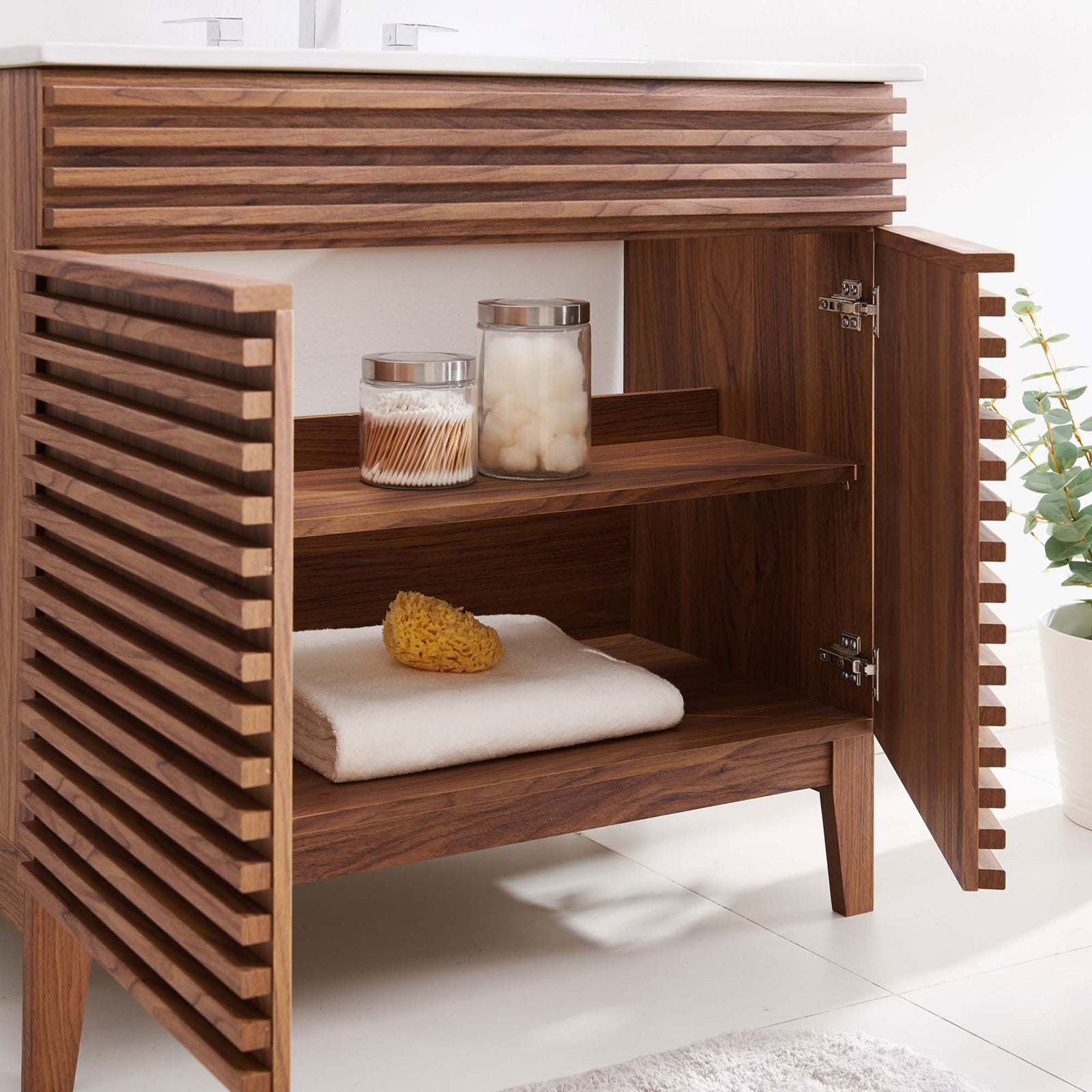 Cabinet opens to a spacious shelf ideal for towels and bath accessories. || EEI-4437-WAL-WHI || storage_open_room