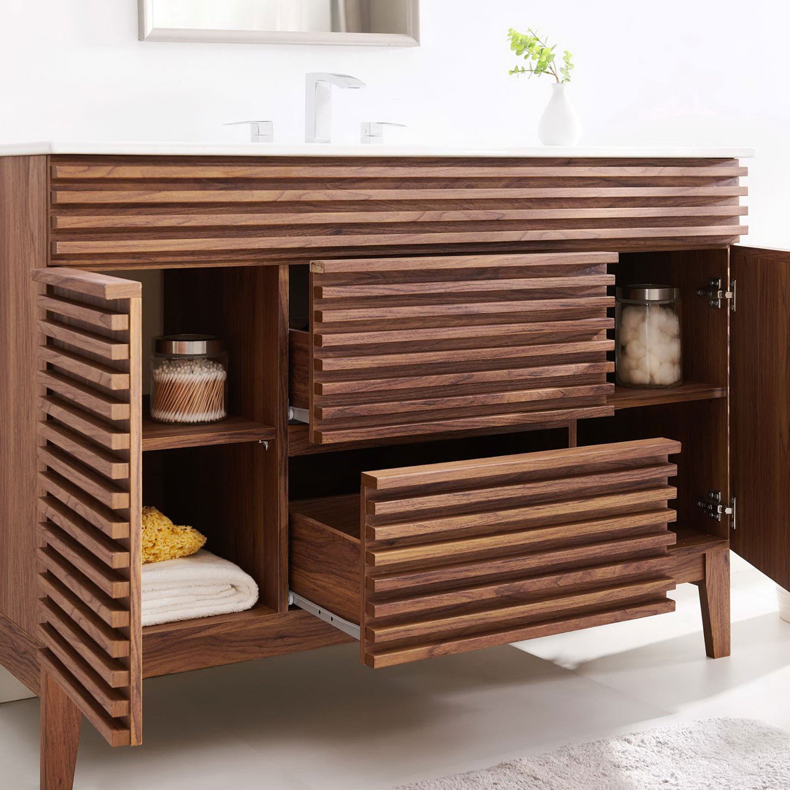 Warm walnut vanity showcases ample storage with open doors and drawers beneath a bright ceramic top. || EEI-4439-WAL-WHI || front_angle_open_room