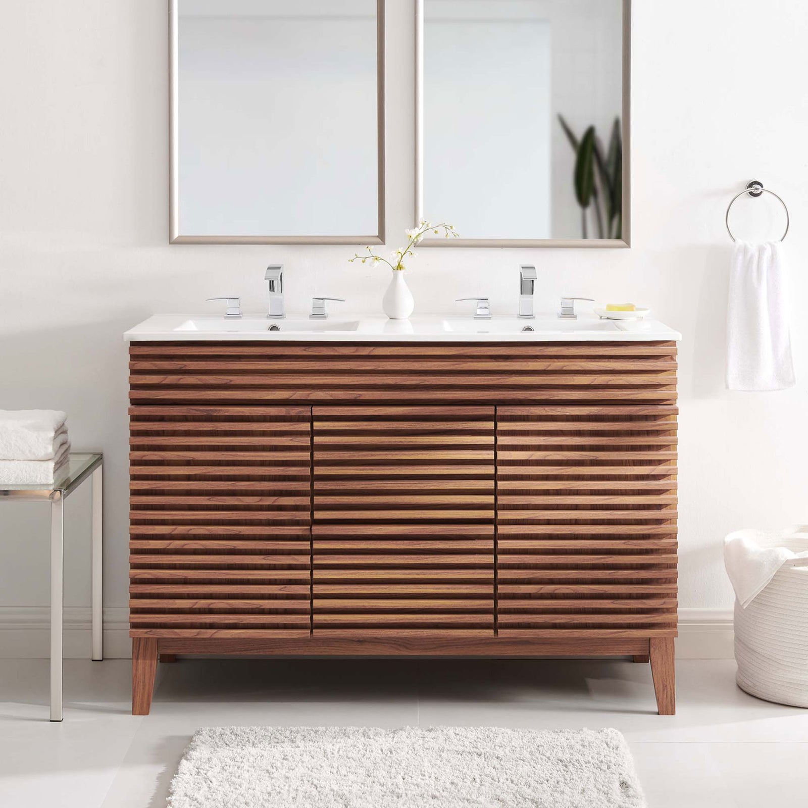 Clean, modern vanity anchors the bath with warm walnut tones and a bright double sink top || EEI-4441-WAL-WHI || front_room