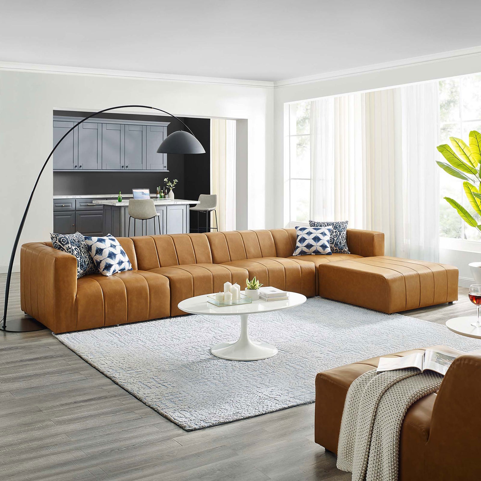 Spacious living room featuring the tan Bartlett sectional with ottoman and modern decor || EEI-4521-TAN || front_angle_room