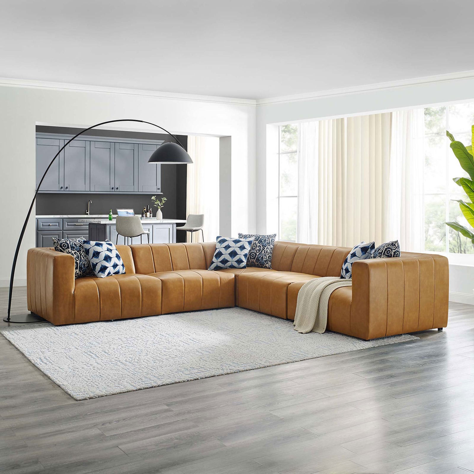 L shaped tan vegan leather Bartlett sectional sofa styled in a bright contemporary living room || EEI-4532-TAN || front_angle_room