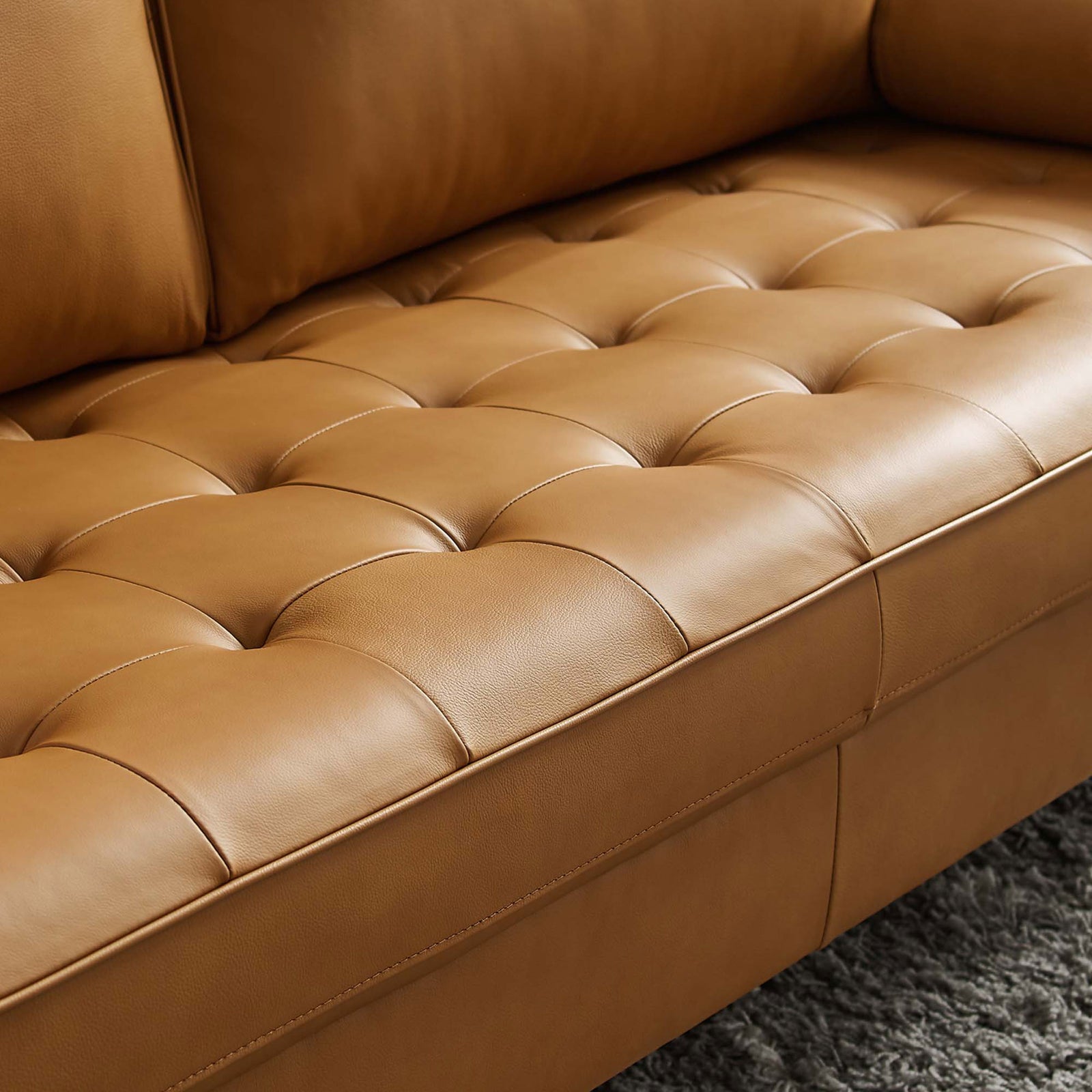 Biscuit-tufted tan leather seat showcasing rich texture and plush cushioning || EEI-4633-TAN || swatch_room