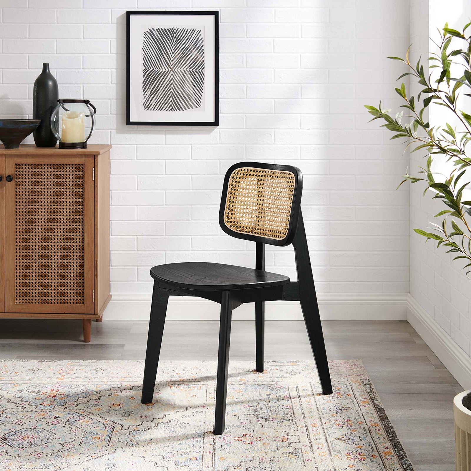 Black wood and rattan cane dining chair lends coastal farmhouse charm to a bright, modern dining space || EEI-4645-BLK || front_angle_room