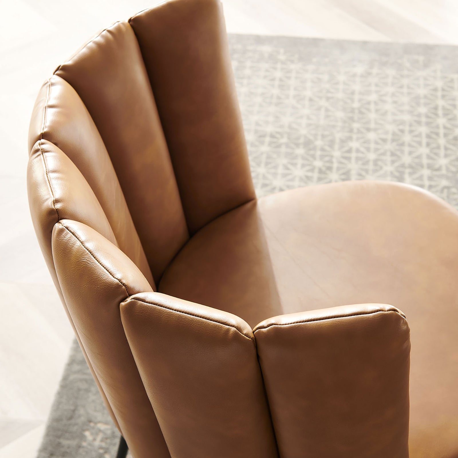 Tan vegan leather upholstery with vertical channel tufting on dining chair back and seat in a bright dining room || EEI-4676-BLK-TAN || detail_room