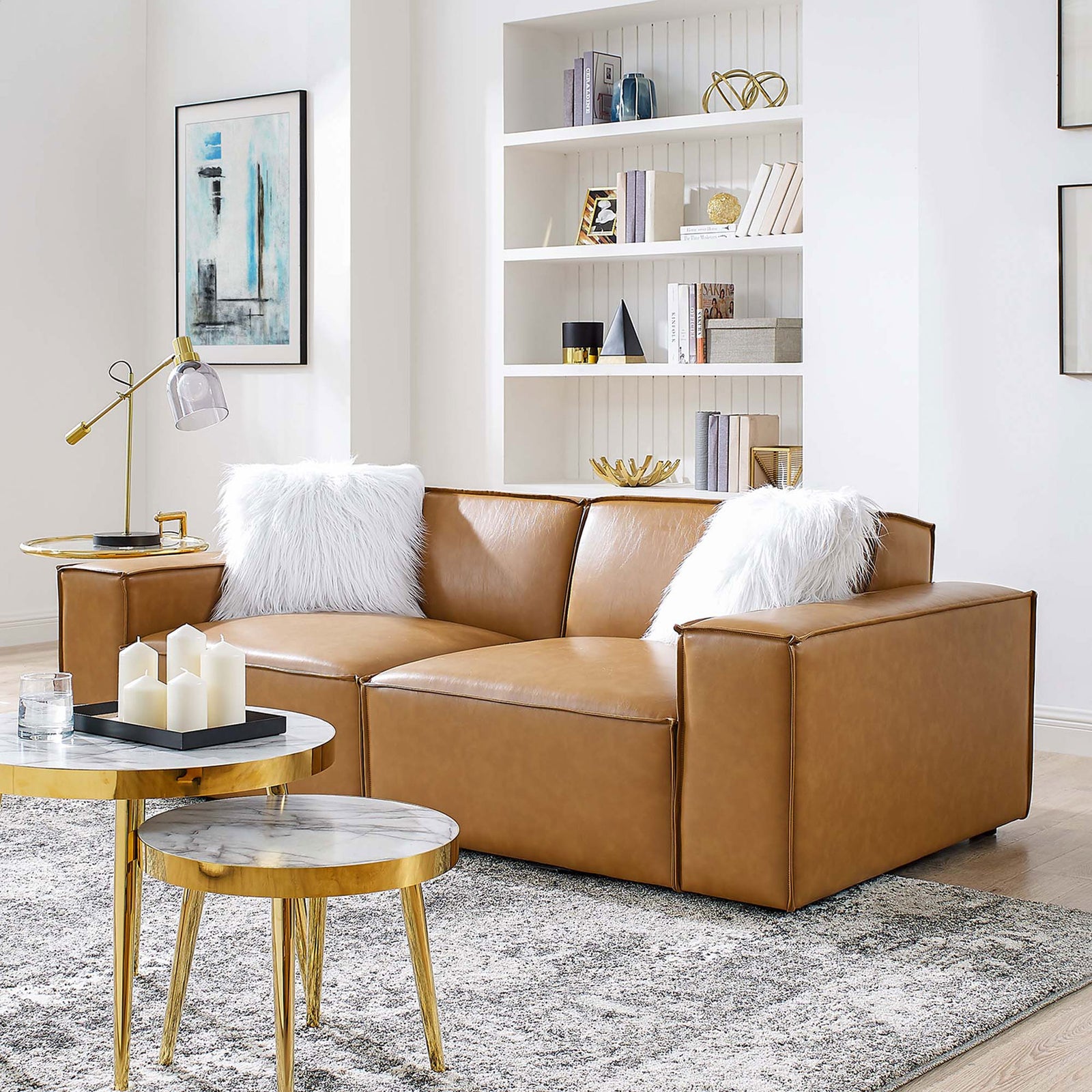 Tan vegan leather loveseat styled in modern living room with gold accents and plush white pillows || EEI-4707-TAN || front_angle_room