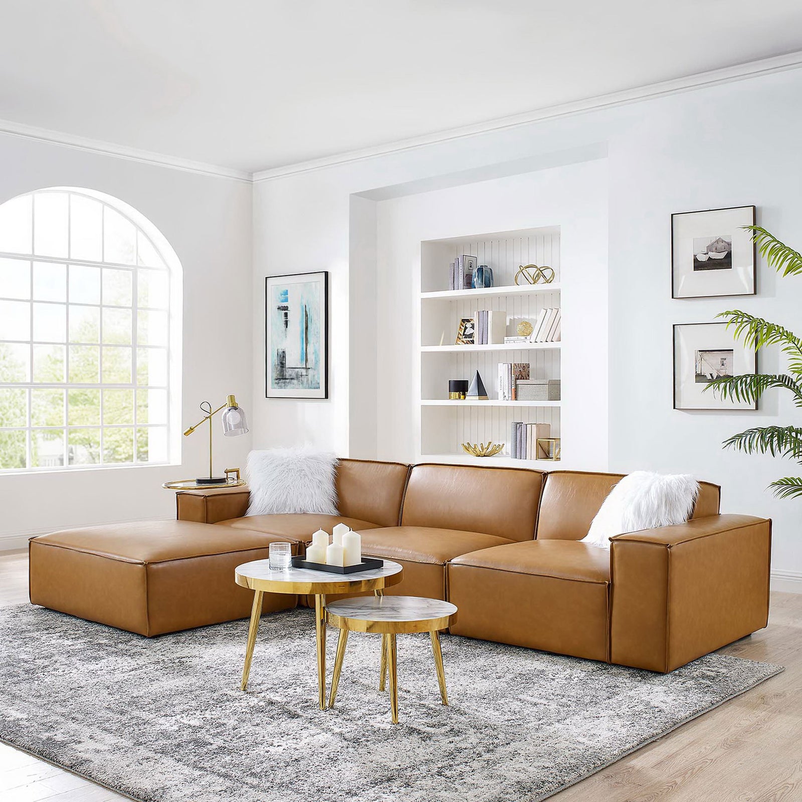 Tan vegan leather sectional anchors a bright modern living room with layered tables and cozy accents || EEI-4709-TAN || front_angle_room