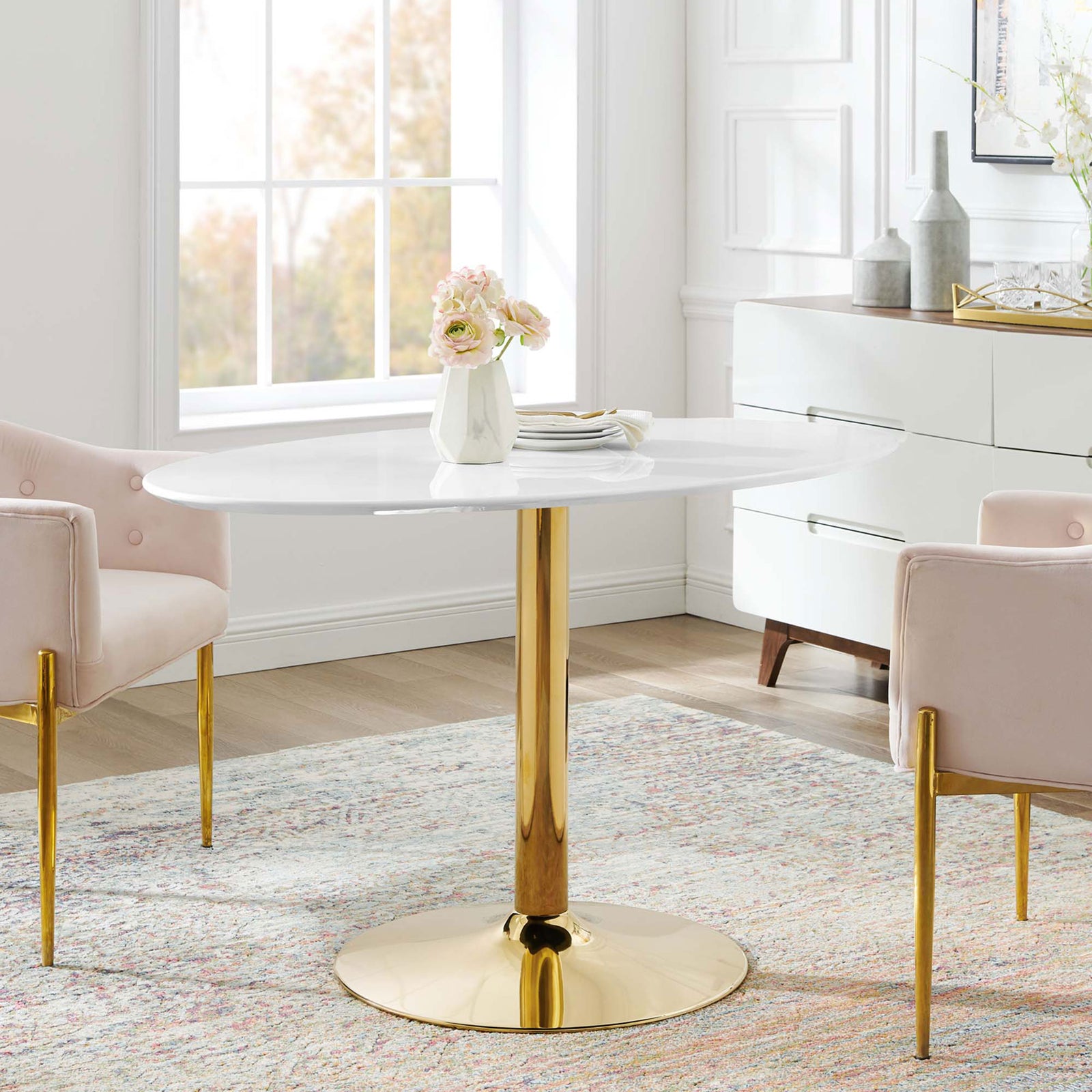 Verne 48-inch oval dining table with blush chairs creating a sophisticated modern dining area || EEI-4750-GLD-WHI || front_room
