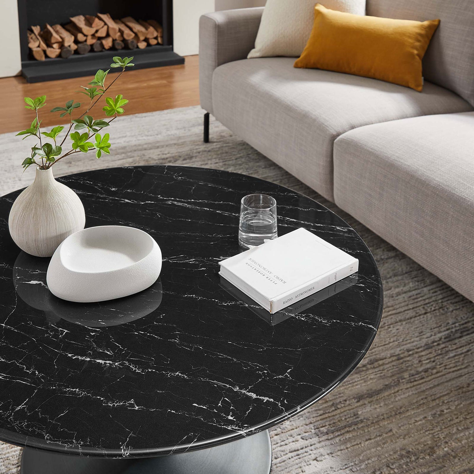Black stone-look surface with striking white veins elevates a modern living room vignette || EEI-4884-BLK-BLK || detail_room