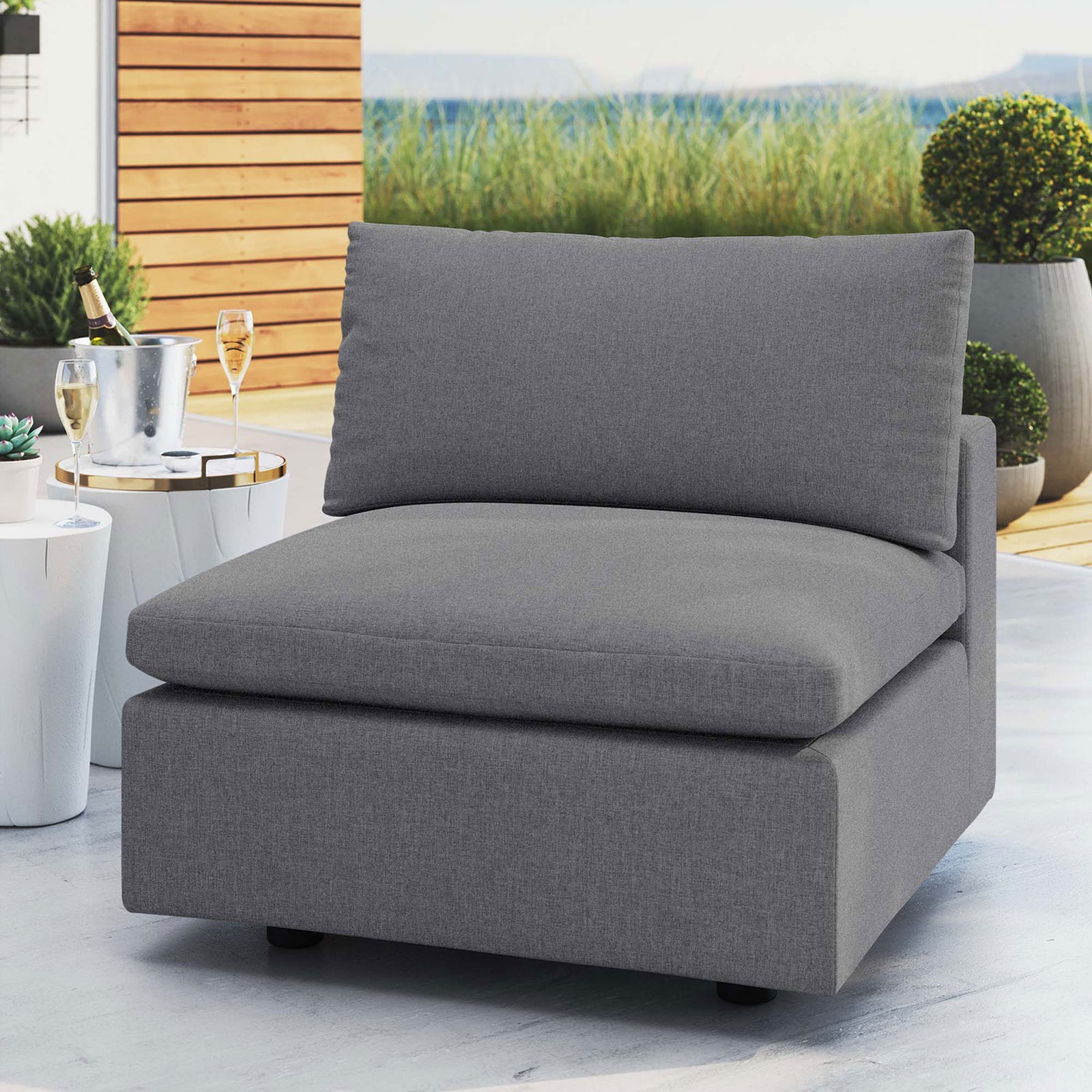 Slate gray Sunbrella armless chair styled on a modern patio, inviting relaxed outdoor lounging || EEI-4905-SLA || front_angle_room