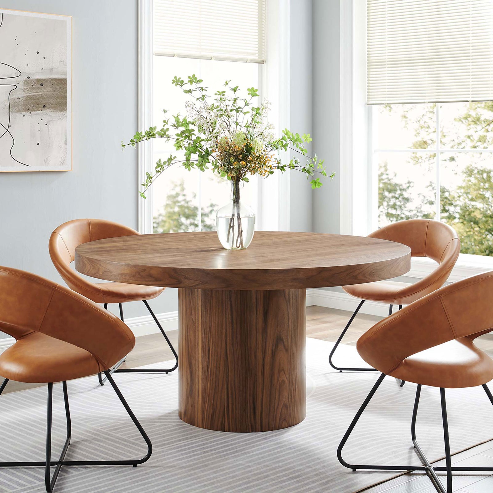 Walnut pedestal dining table anchors a contemporary dining room with cozy seating || EEI-4911-WAL || front_angle_room