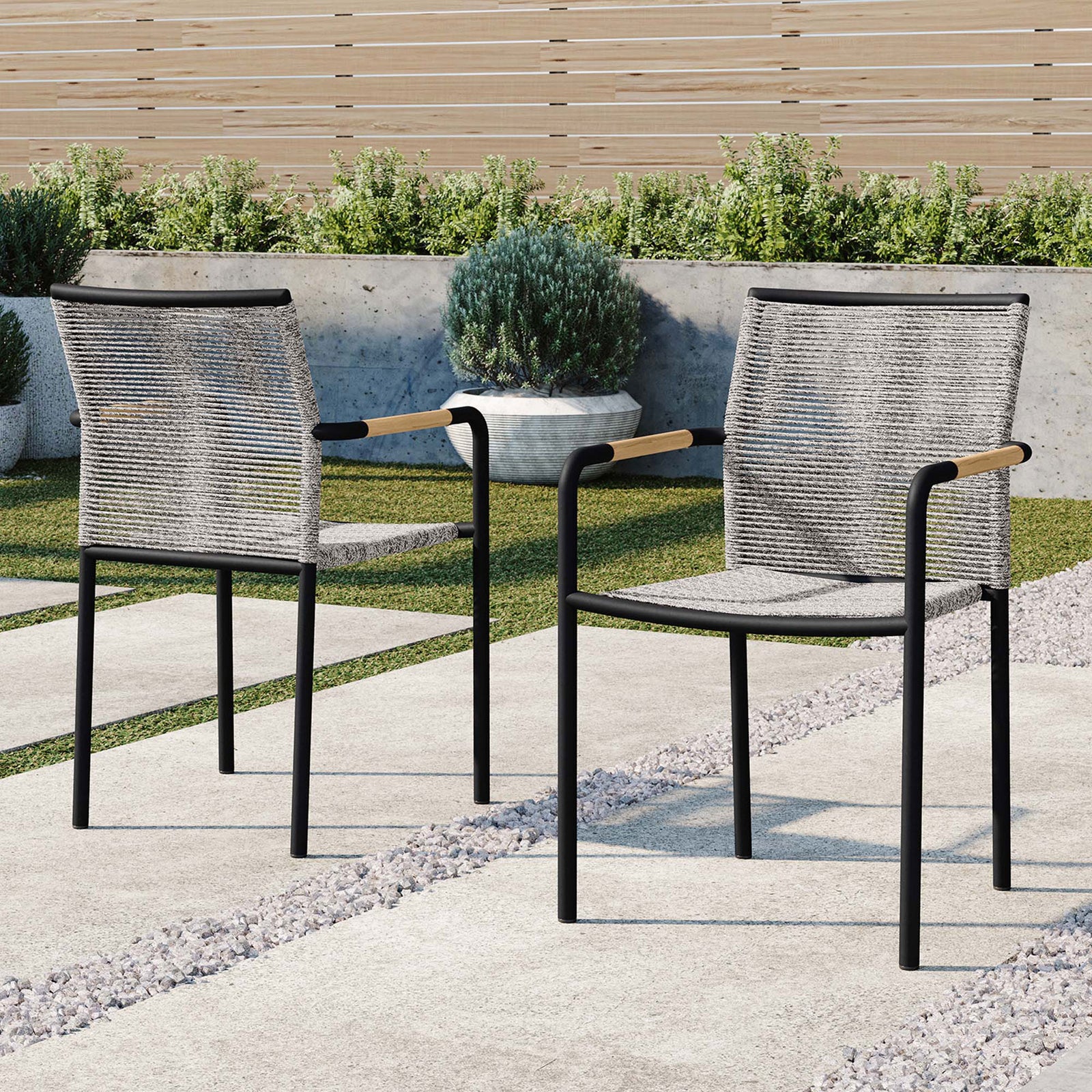 Pair of outdoor rope dining chairs styled on a modern stone patio with garden backdrop || EEI-5036-LGR || front_angle_multi_room