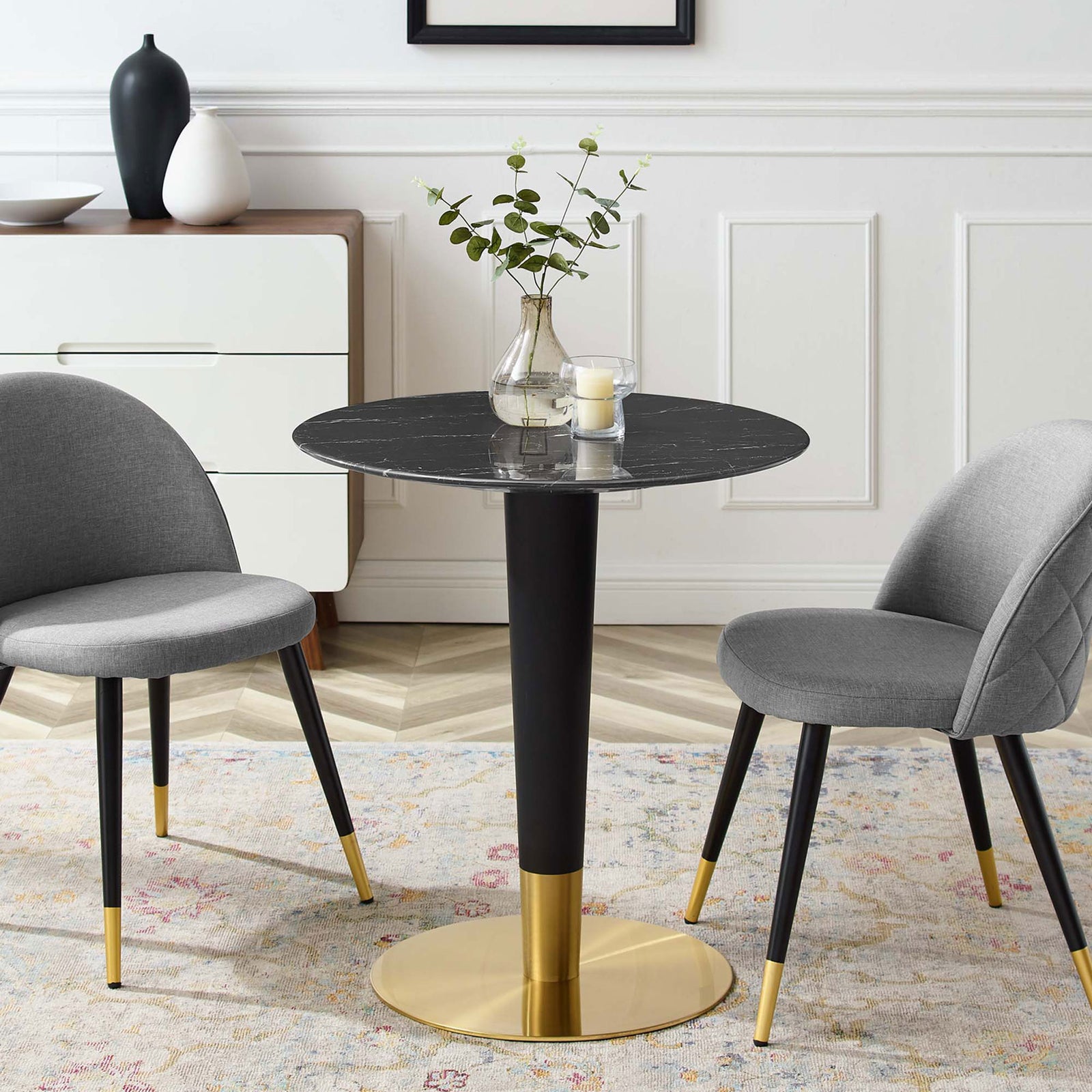 Small round black artificial marble dining table styled with gray chairs in a bright dining room || EEI-5131-GLD-BLK || front_angle_room